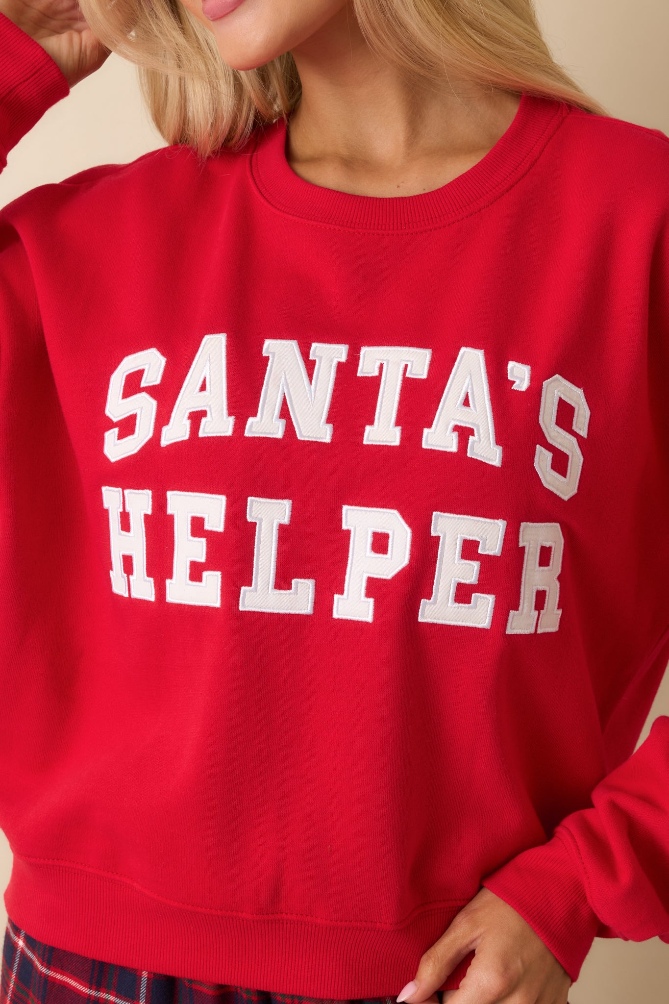 Twill “Santa’s Helper” applique on red fleece, showcasing texture and soft midweight fabric.