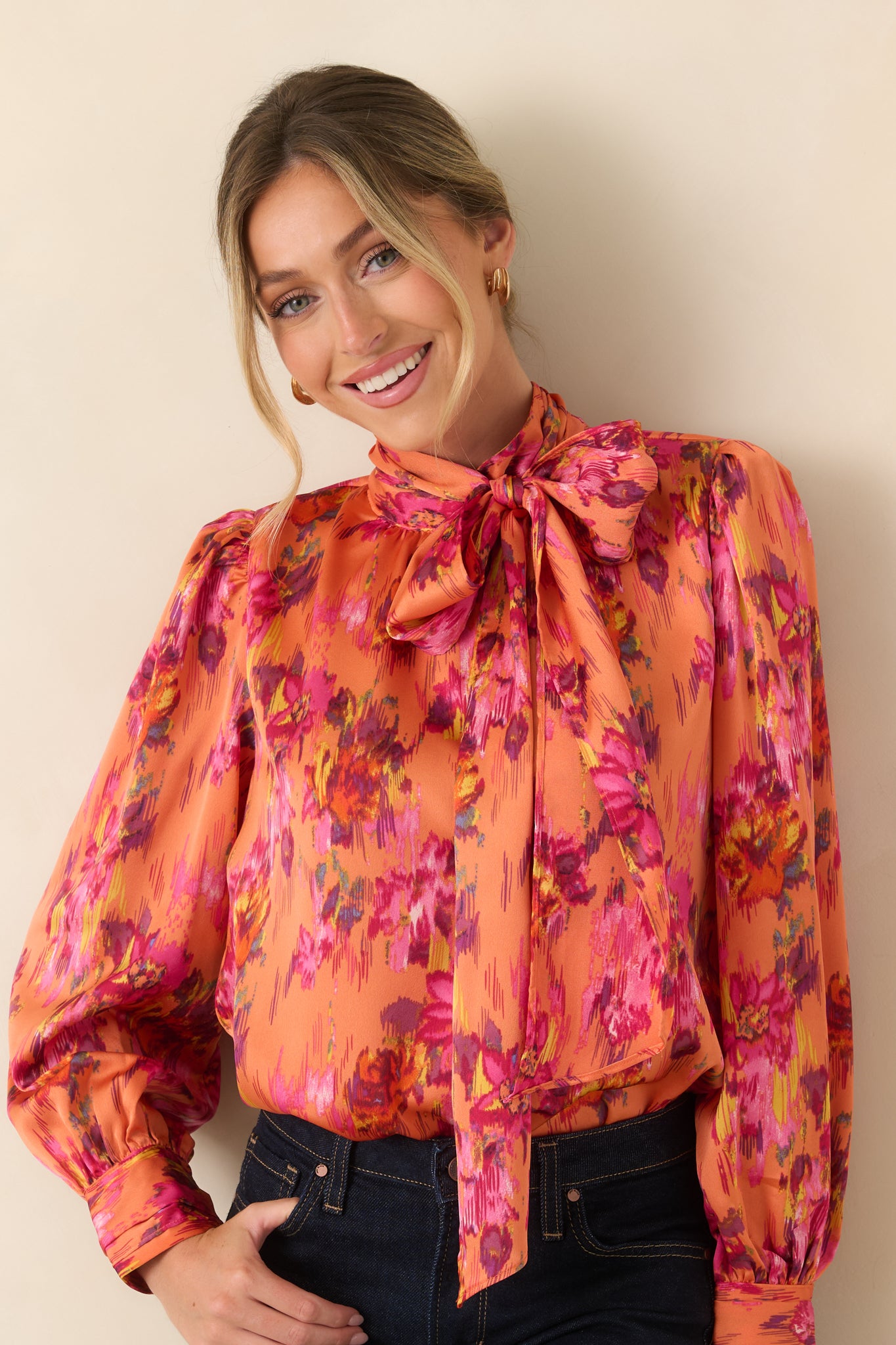Sleeve detail of the satin blouse highlighting the full balloon shape and buttoned cuffs.