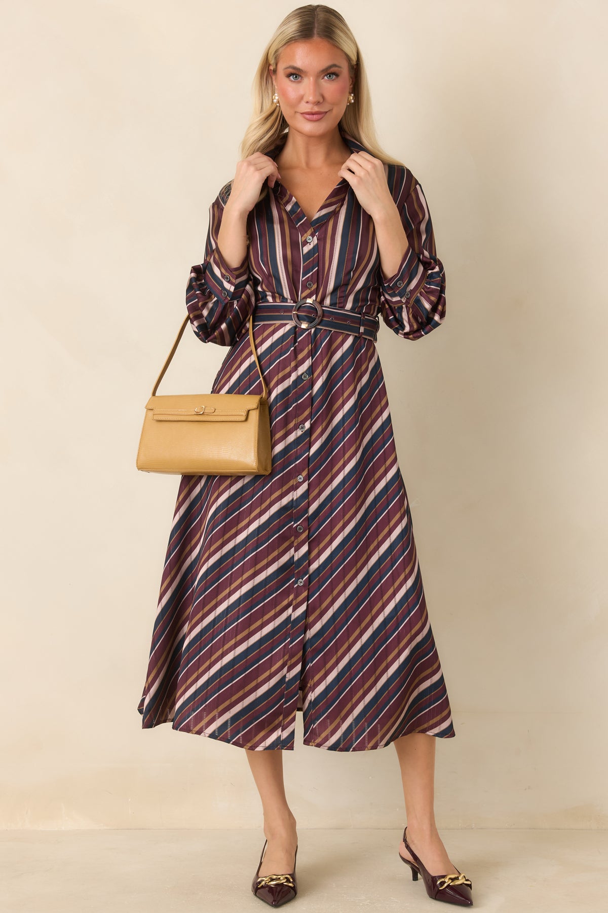 Striped satin dress with a classic collared neckline, button front, and removable self belt.