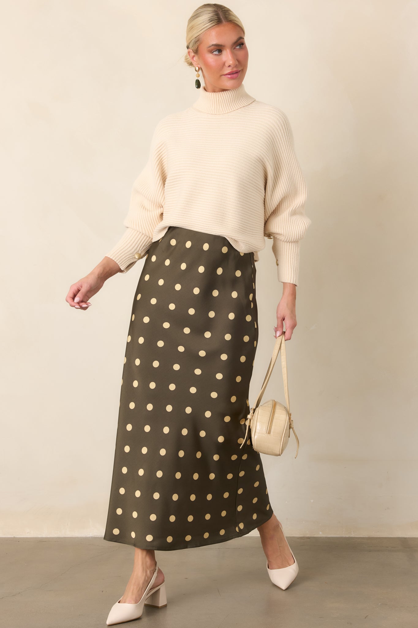 Silky satin skirt showcasing a vintage-inspired cream polka dot pattern, comfortable elastic waistband, and softly flowing bias-cut shape.