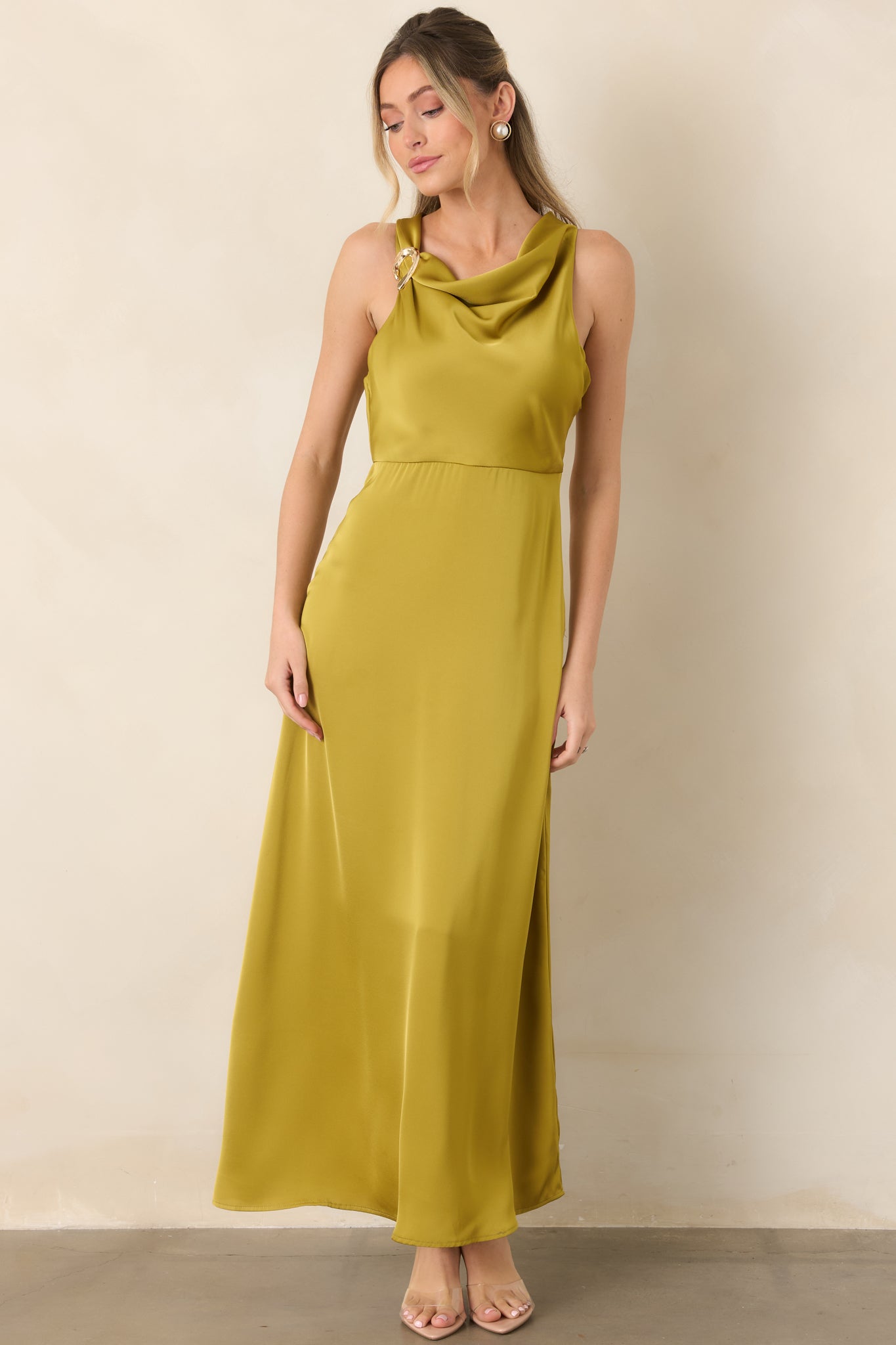 Polished satin maxi silhouette with an elevated shoulder accent, flattering empire seam, and smooth skirt that falls with graceful movement.