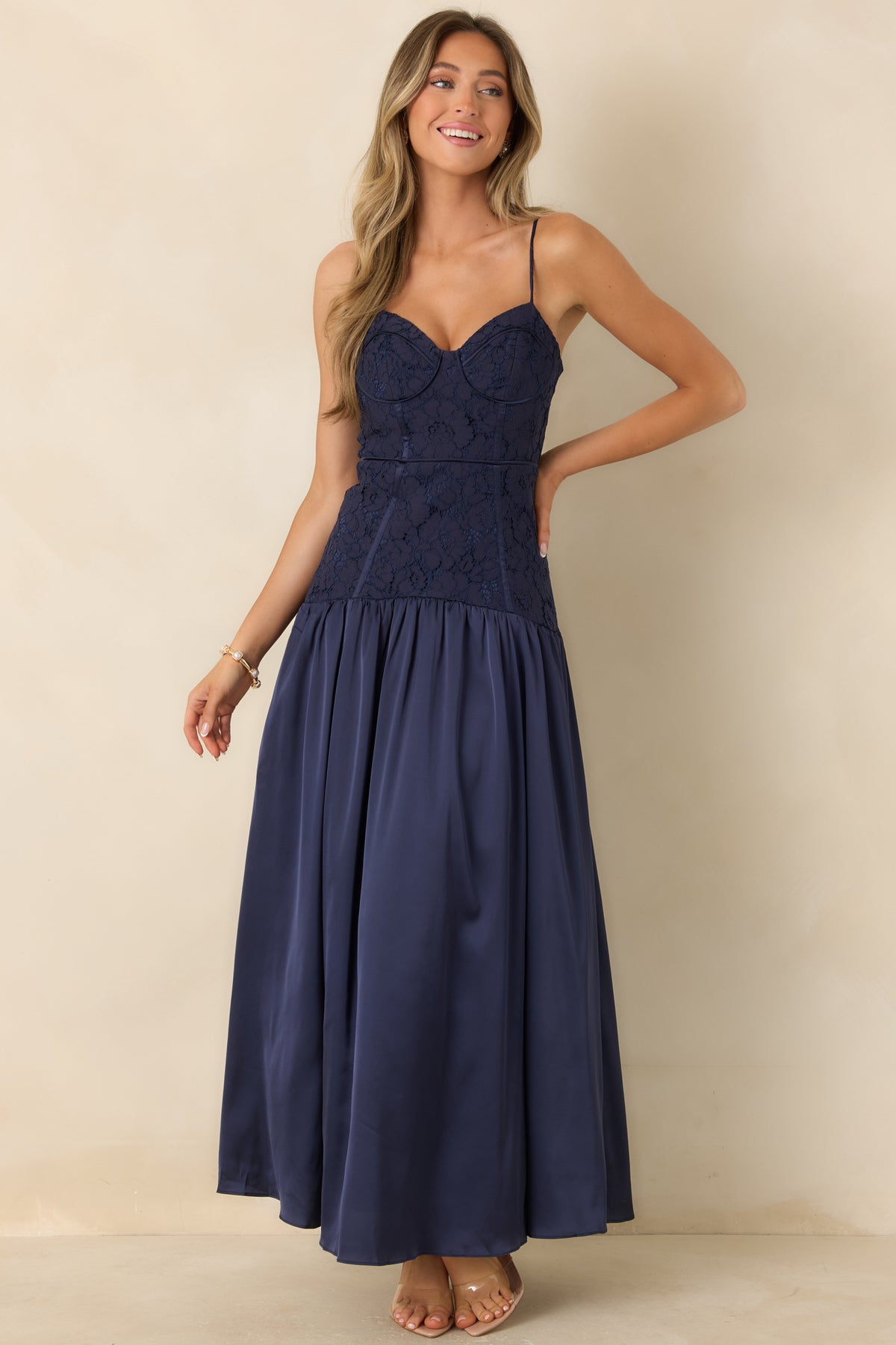 Satin drop-waist maxi dress with a fitted lace bodice and a voluminous gathered skirt.