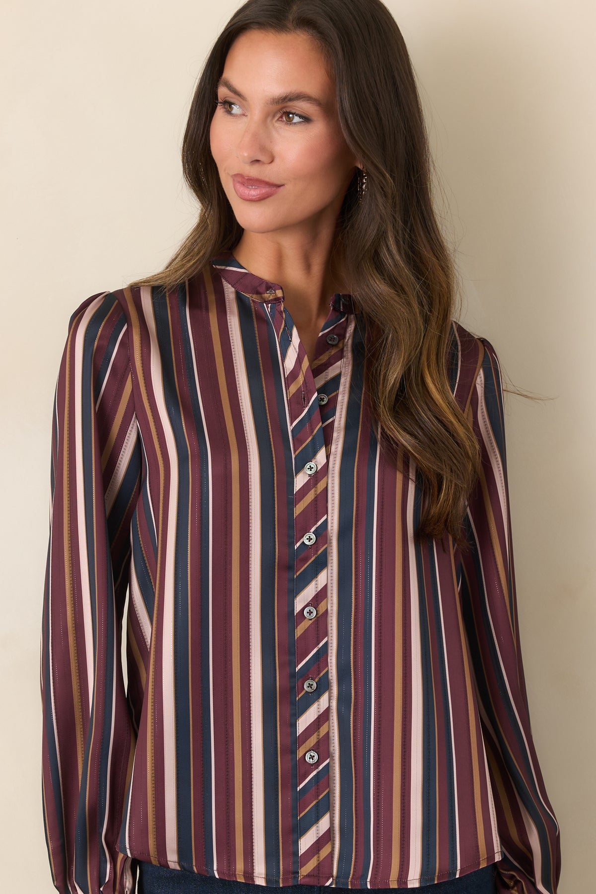 Satin blouse featuring elasticized cuffs that gather the long balloon sleeves.
