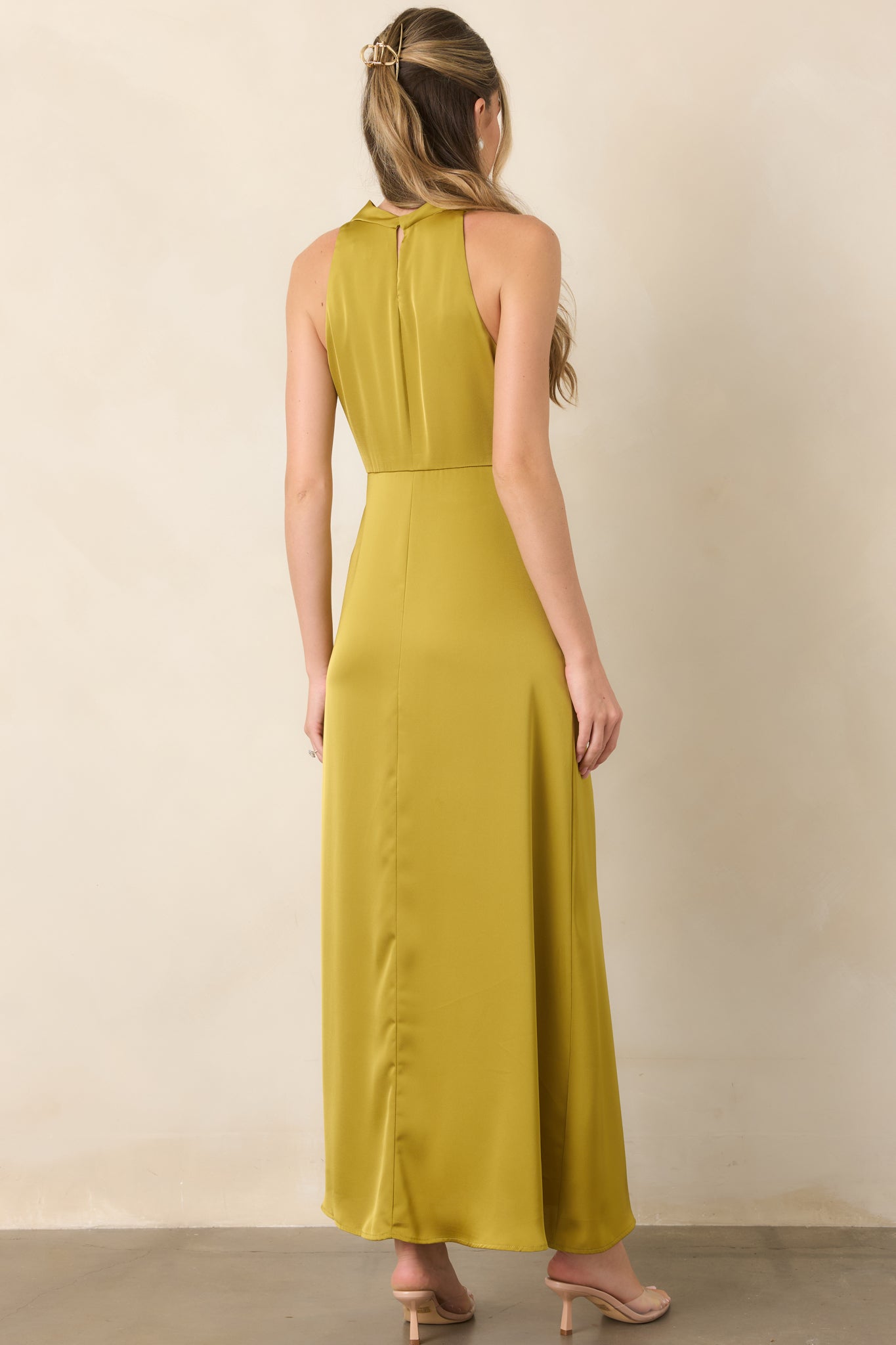 Rear view of the satin maxi dress showcasing its flowing A-line skirt, smooth back, and keyhole closure with a single button.