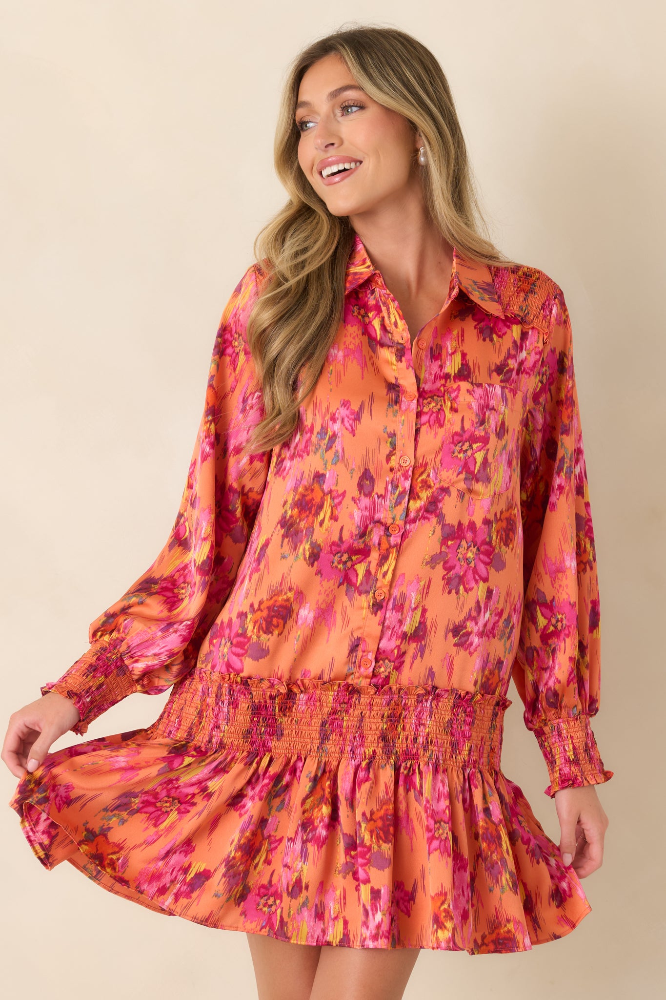 Front detail highlighting the smocked drop waist and gathered fabric that creates the dress's relaxed, flouncy shape.