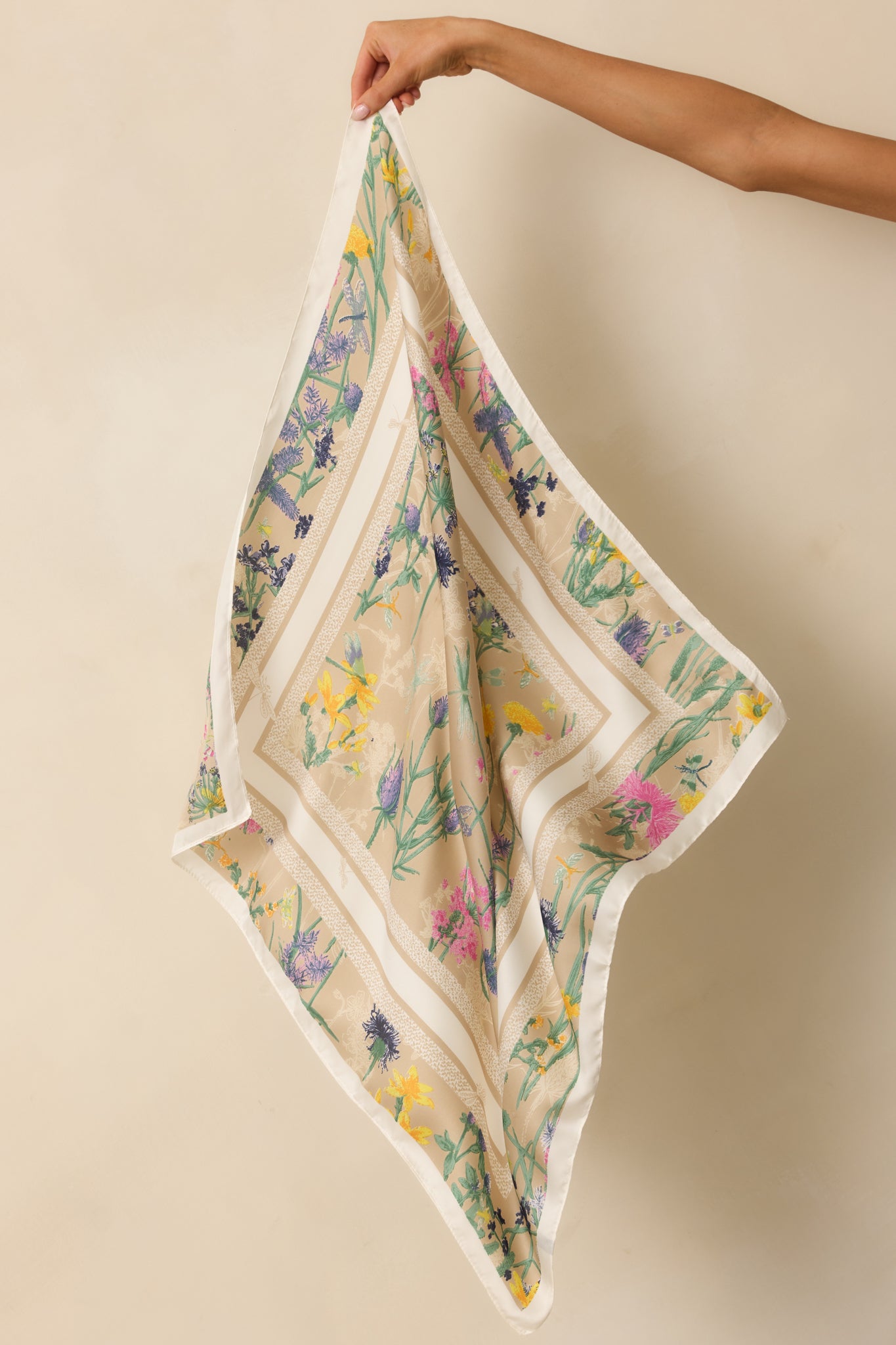 An angled full view showing the shiny satin finish and contrasting border pattern around the floral print.