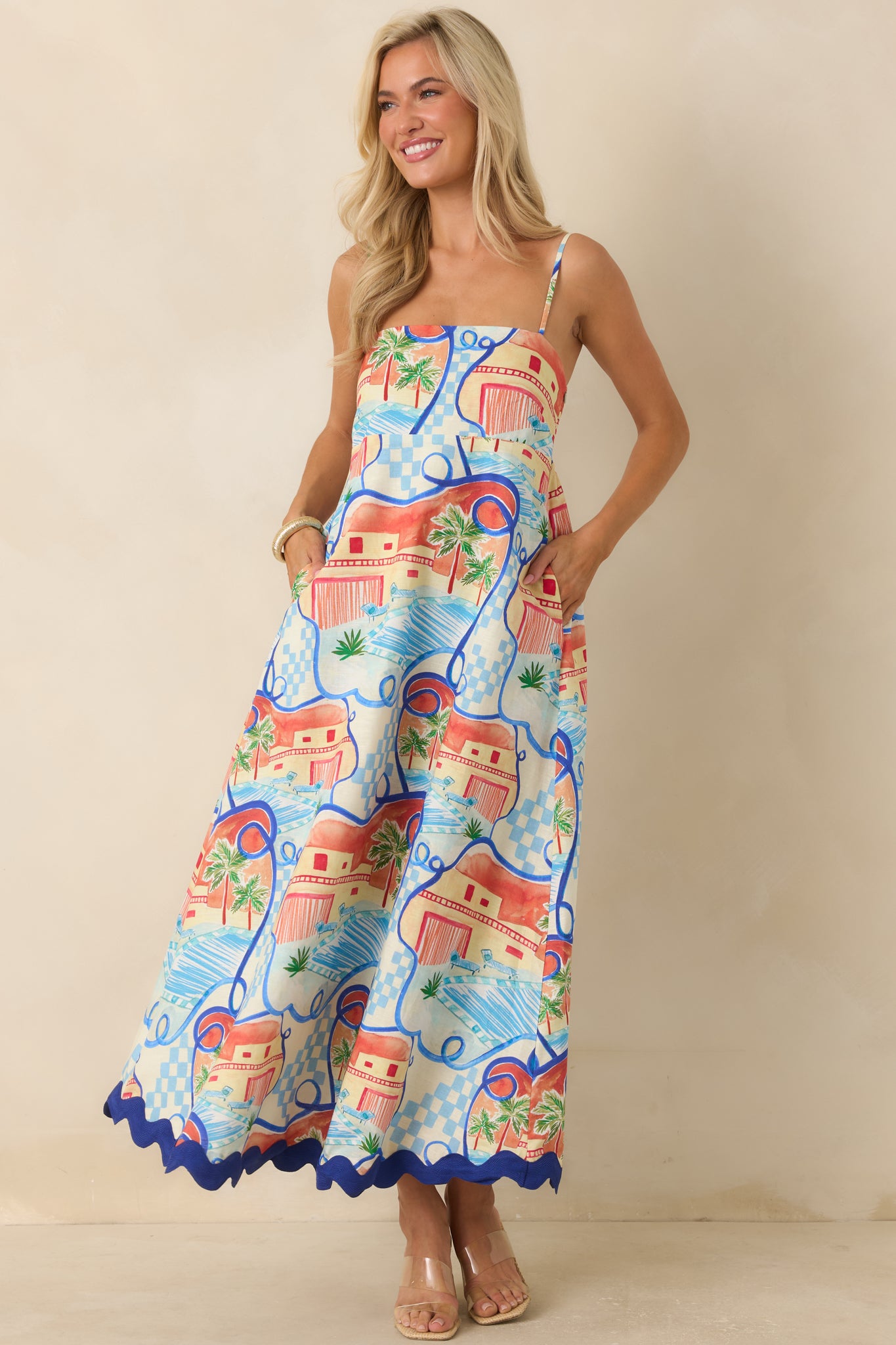 Scenic print maxi dress featuring playful geometric details, a comfortable silhouette, and a contrasting blue hem accent.
