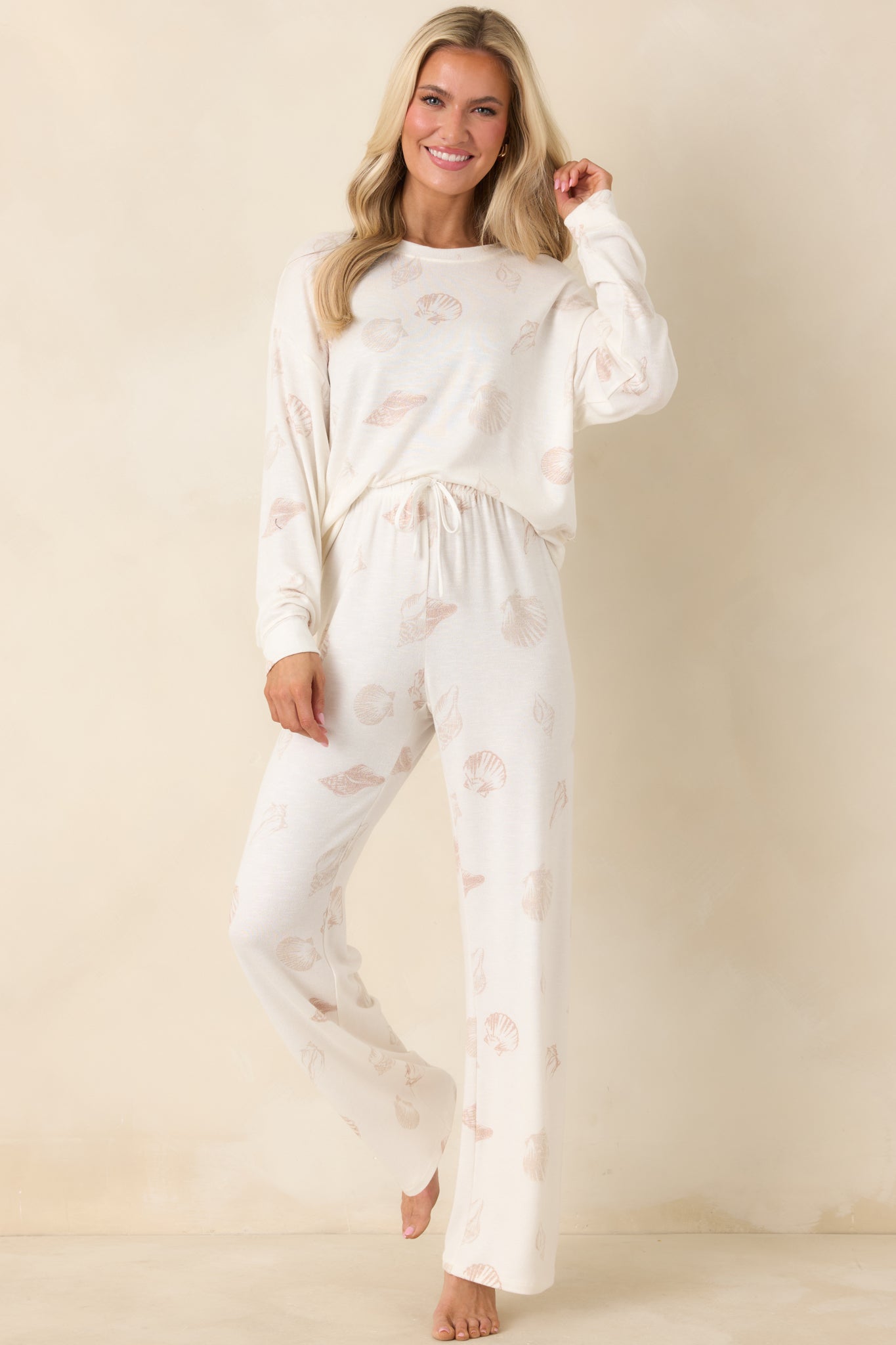 Seashell print lounge pants in soft ivory knit featuring a comfortable pull-on waistband and airy, flowing leg shape.