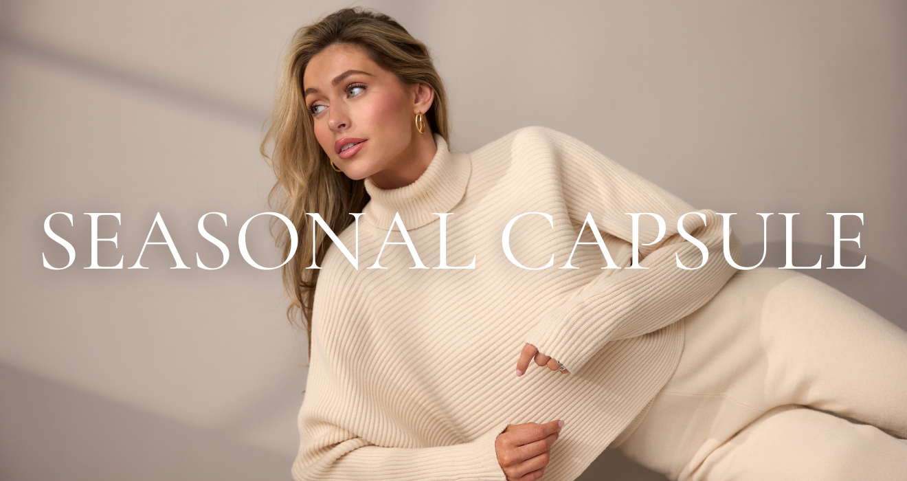 Woman wearing a cream sweater with 'SEASONAL CAPSULE' text overlay on a plain background.