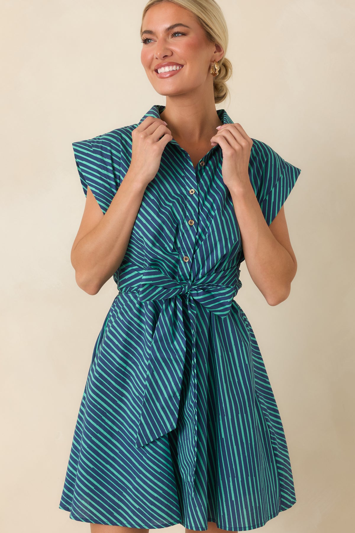 Close view of the self-tie waist highlighting the adjustable detail and flattering shape of the striped mini dress.