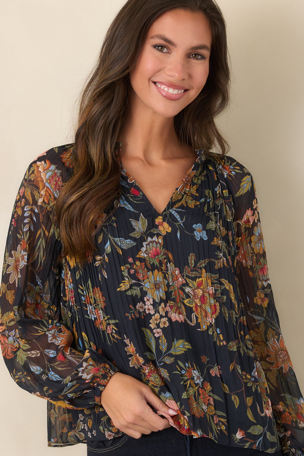 Sheer balloon sleeve top featuring elasticized cuffs and a vibrant multicolor botanical pattern.