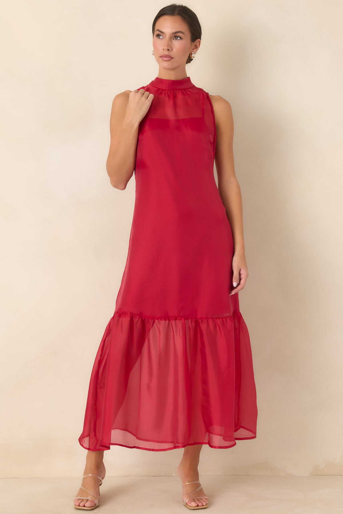 Sheer maxi dress with a streamlined bodice, high neckline, and softly gathered flowing skirt.