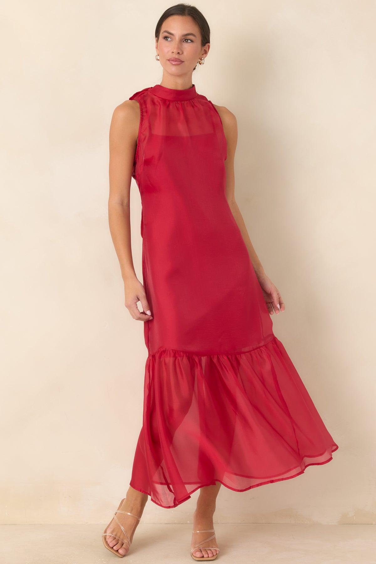 Sheer organza maxi dress with a high neckline, flowing silhouette, and softly gathered hem.