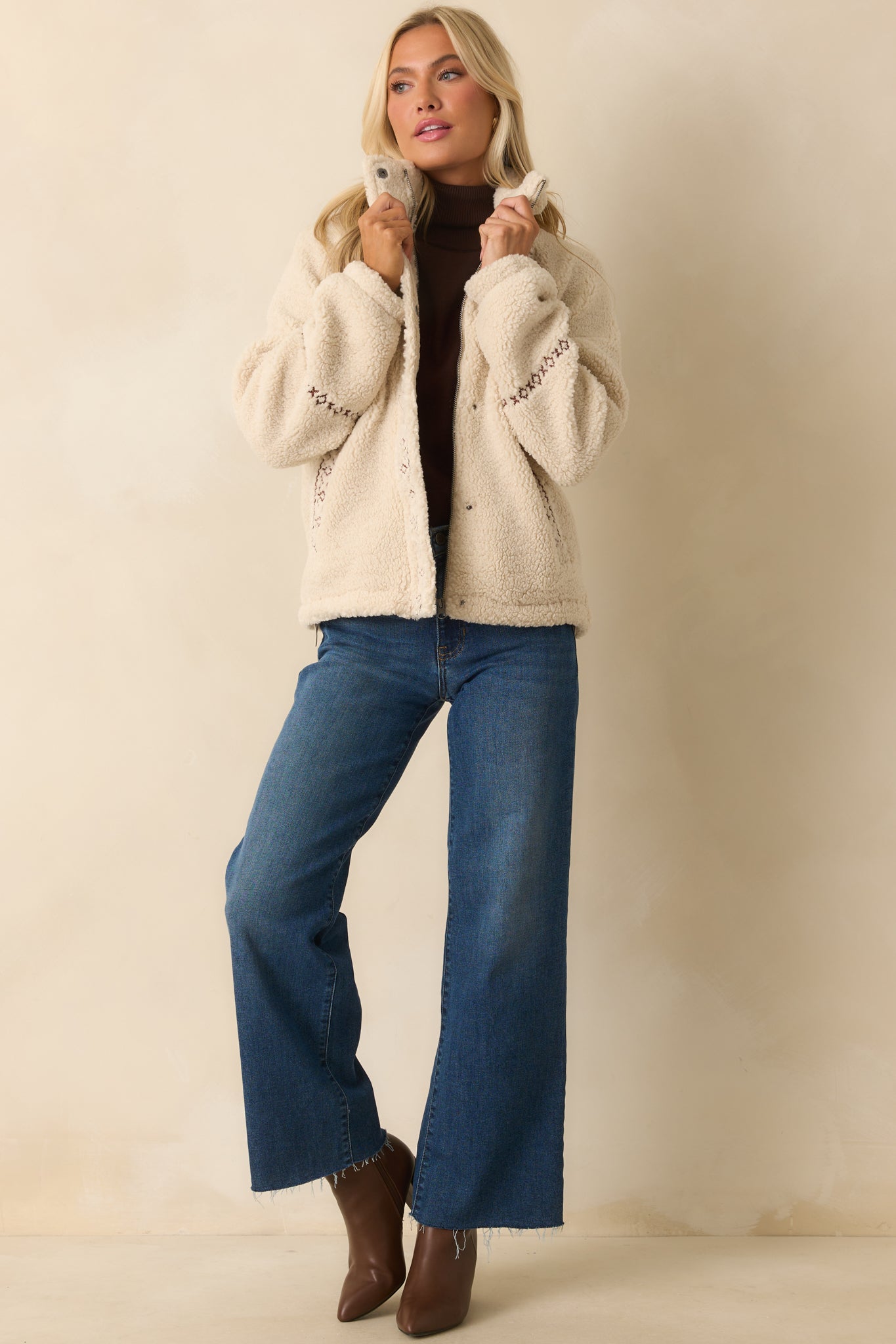 Sherpa jacket in ivory with long sleeves and relaxed, slightly structured silhouette.