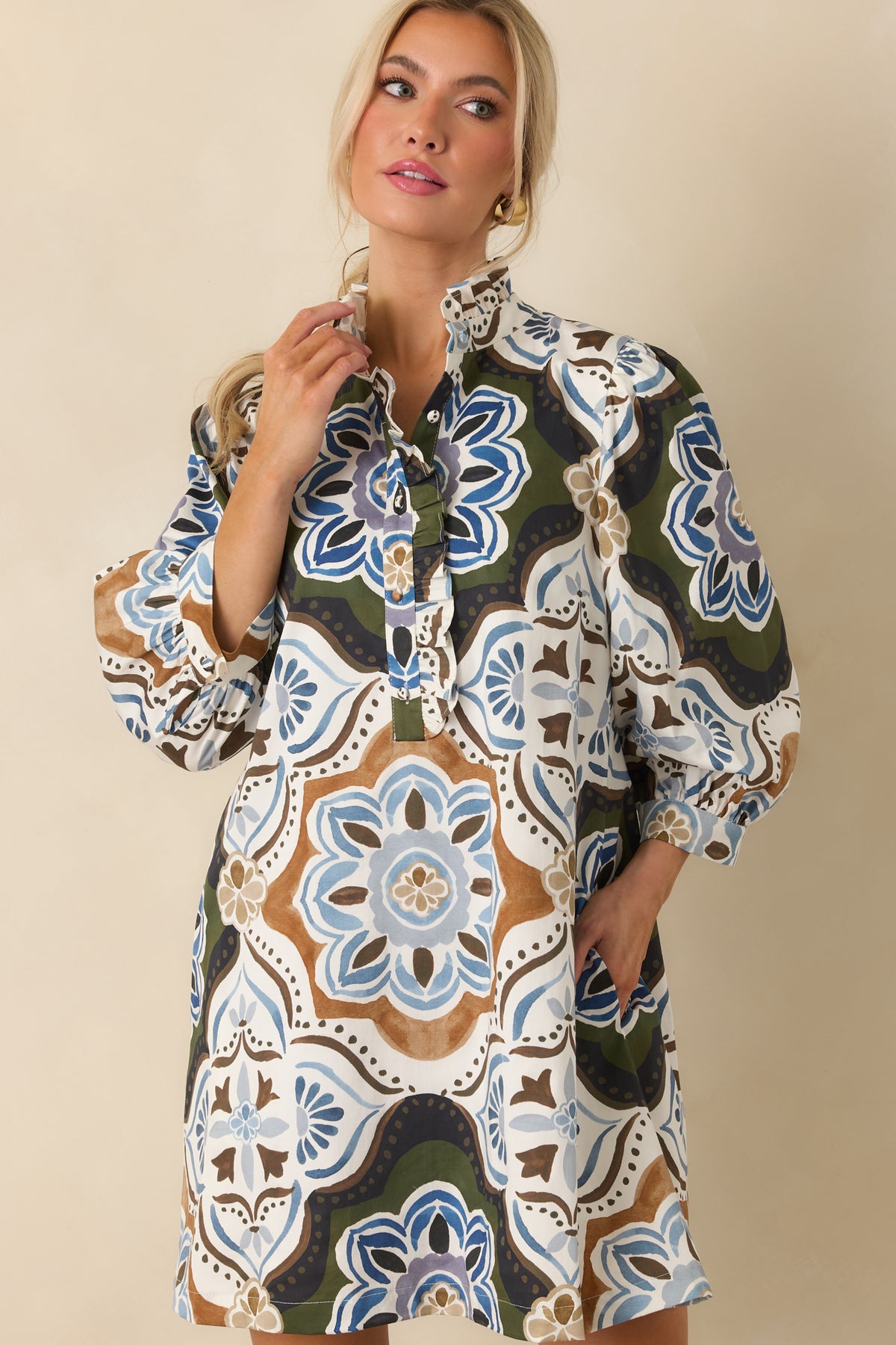 Close view of the shift dress highlighting its oversized olive, ivory, blue, camel, and brown medallion print.