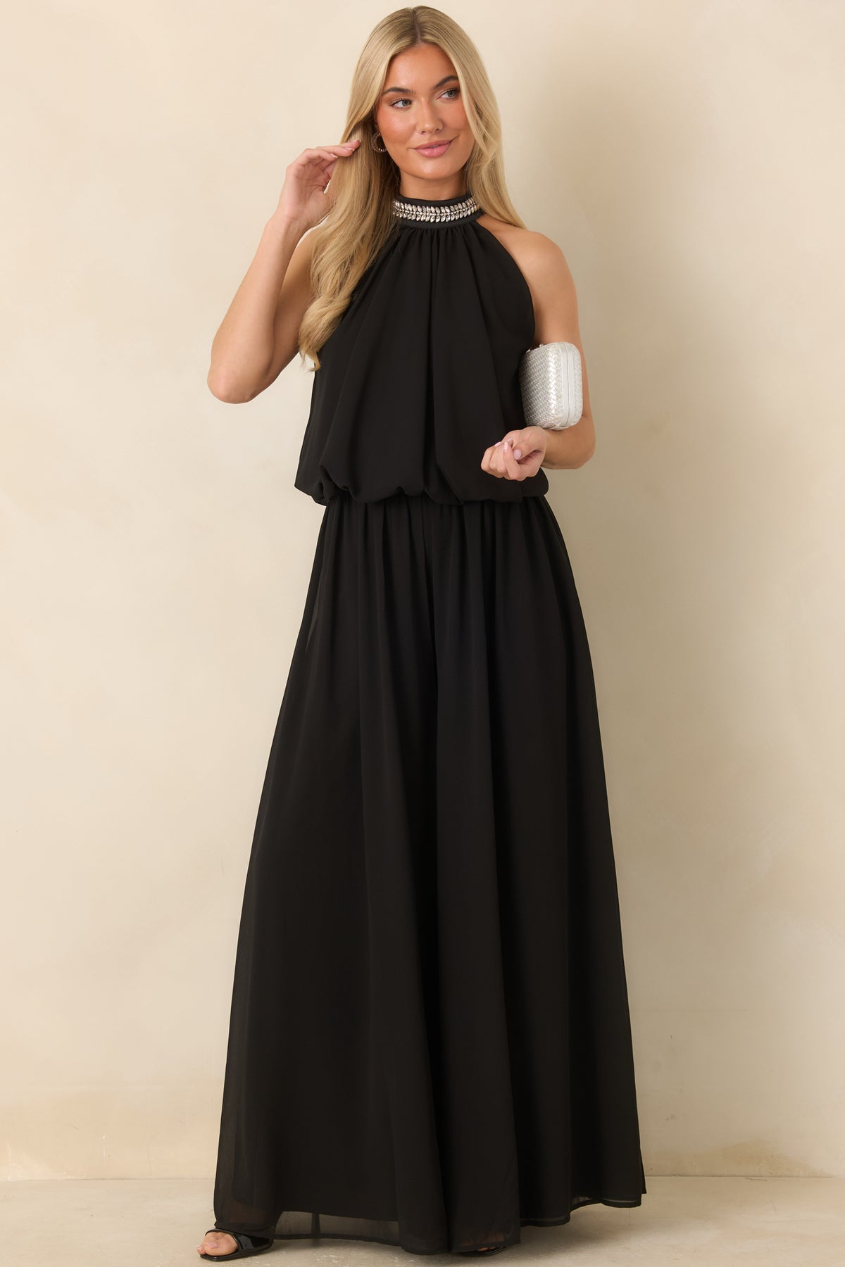 Sleeveless halter top featuring a shimmering rhinestone-trimmed neckline and a relaxed, gathered silhouette.