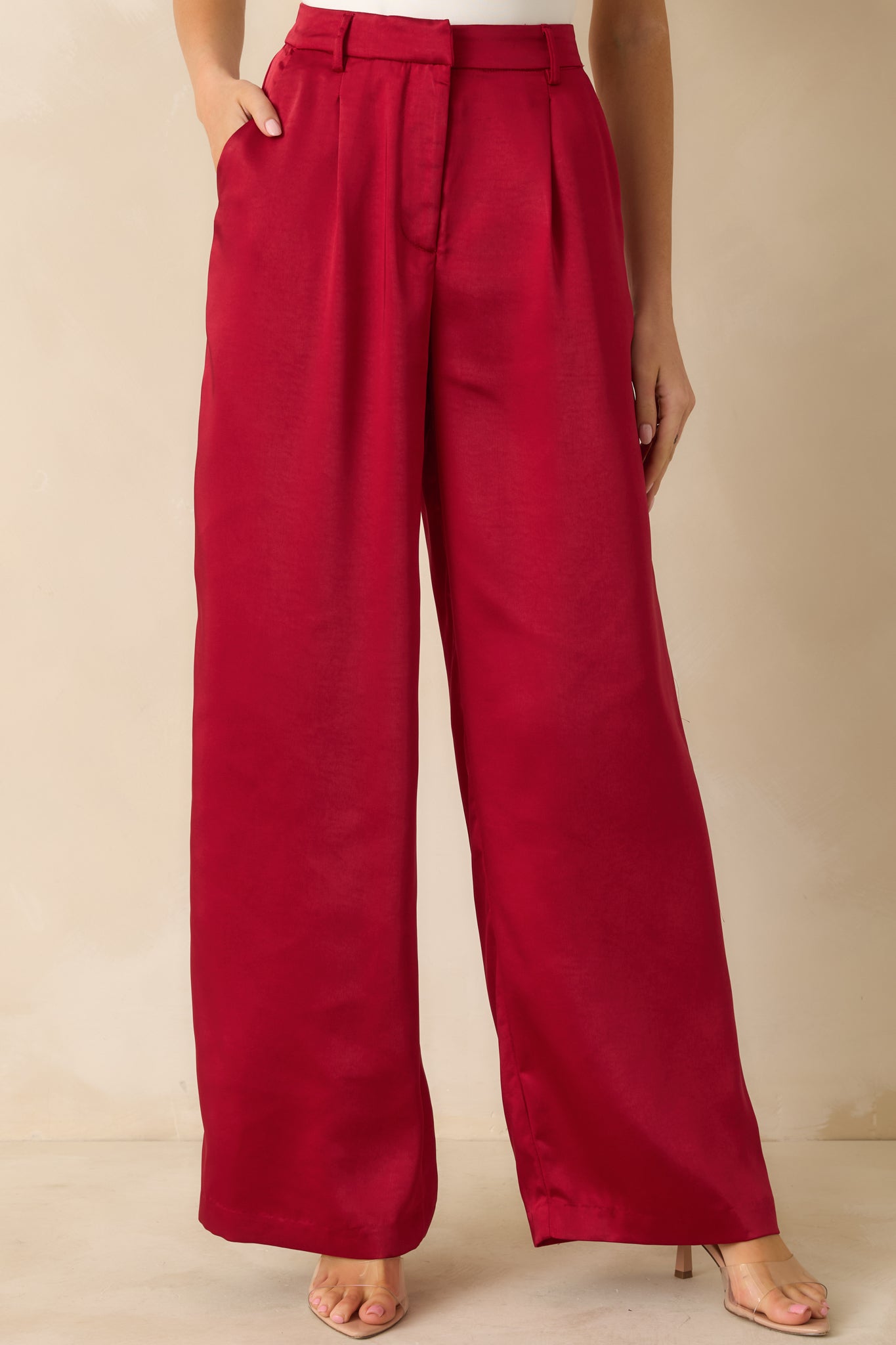 Shimmery red pants featuring a medium-weight polyester-spandex blend, hidden front zipper with hook-and-bar closure, and faux back welt pockets.