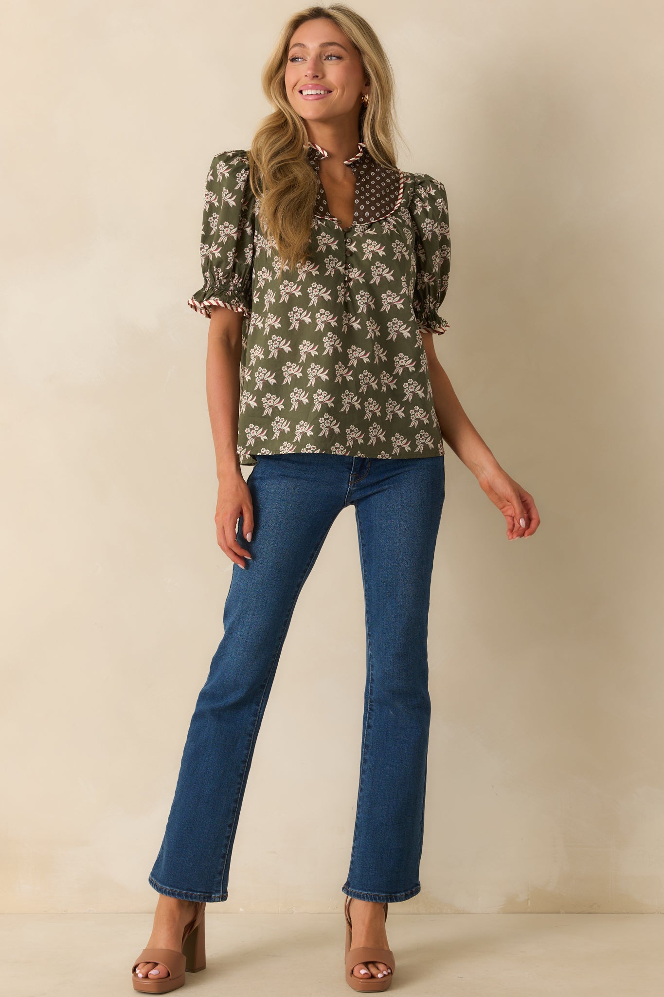 Short puff sleeve top featuring a ruffled stand collar and functional half-button front.