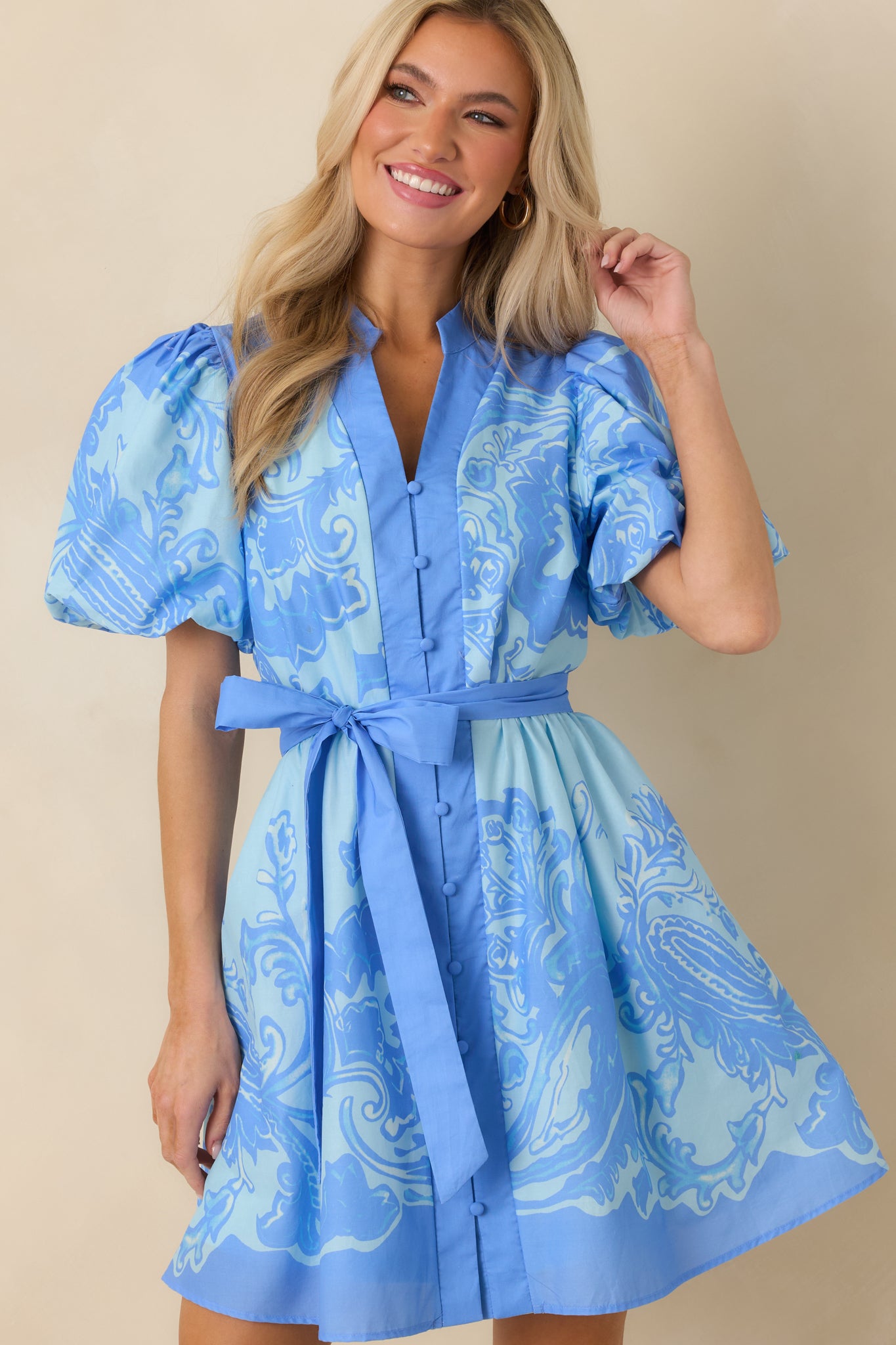 Focused look at the short puff sleeves with subtle volume and lightweight cotton texture.