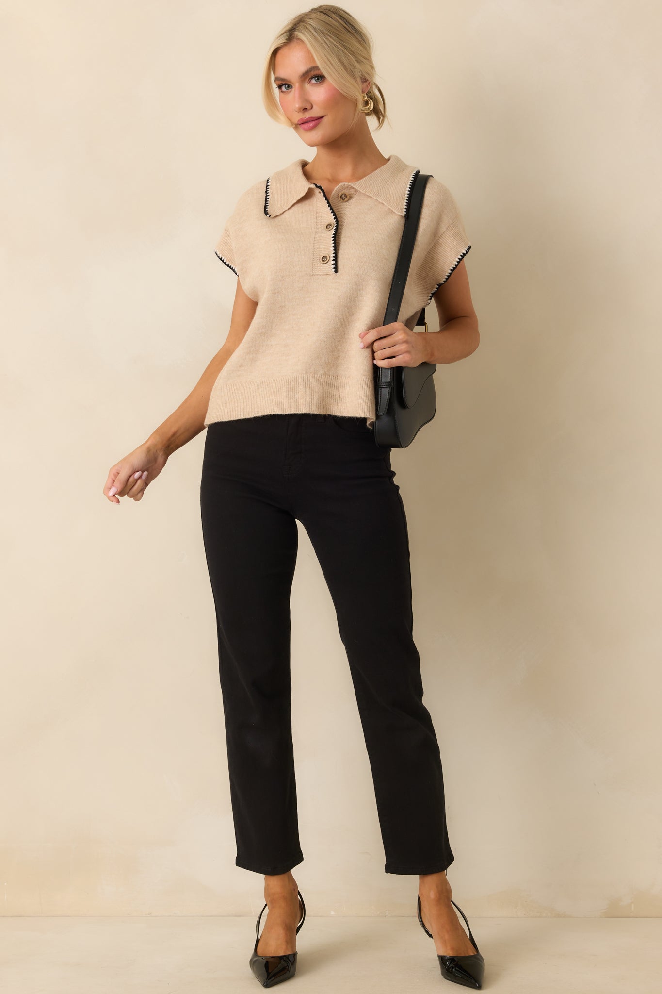 Short-sleeve beige top with functional buttons, collared neckline, and slightly loose silhouette.