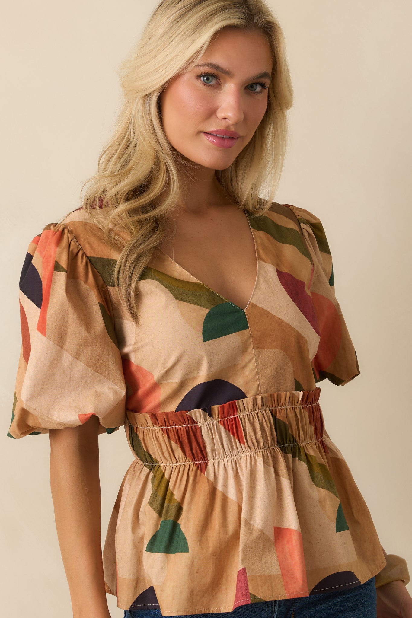 Detail of short sleeves with elastic cuffs and layered peplum hem.