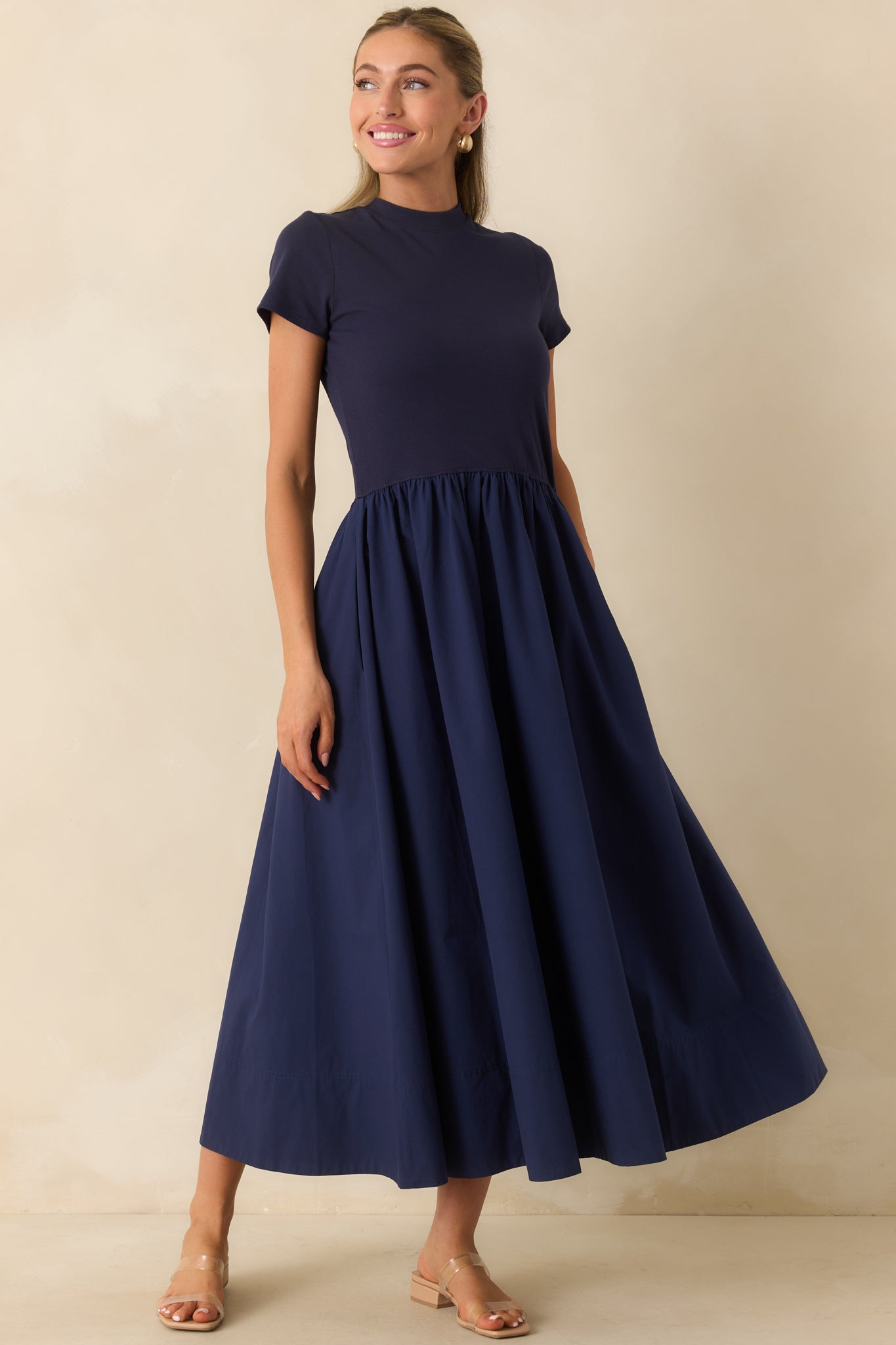 Cotton midi dress showcasing short sleeves, a fitted waistline, and elegant gathered skirt detailing.