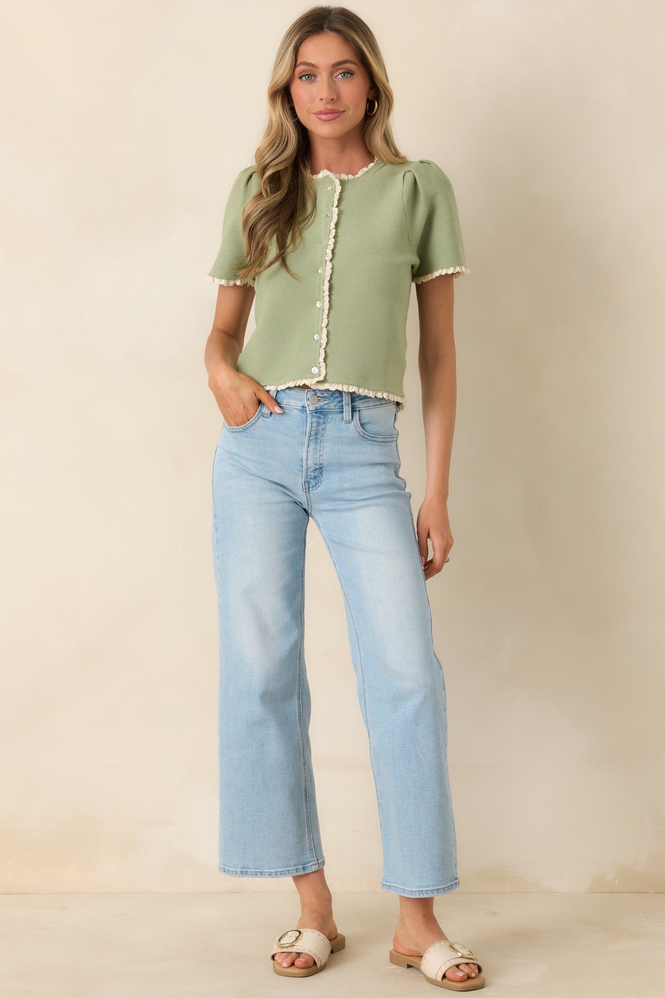 Short sleeve knit top with button front and lace trim detailing along neckline and placket.