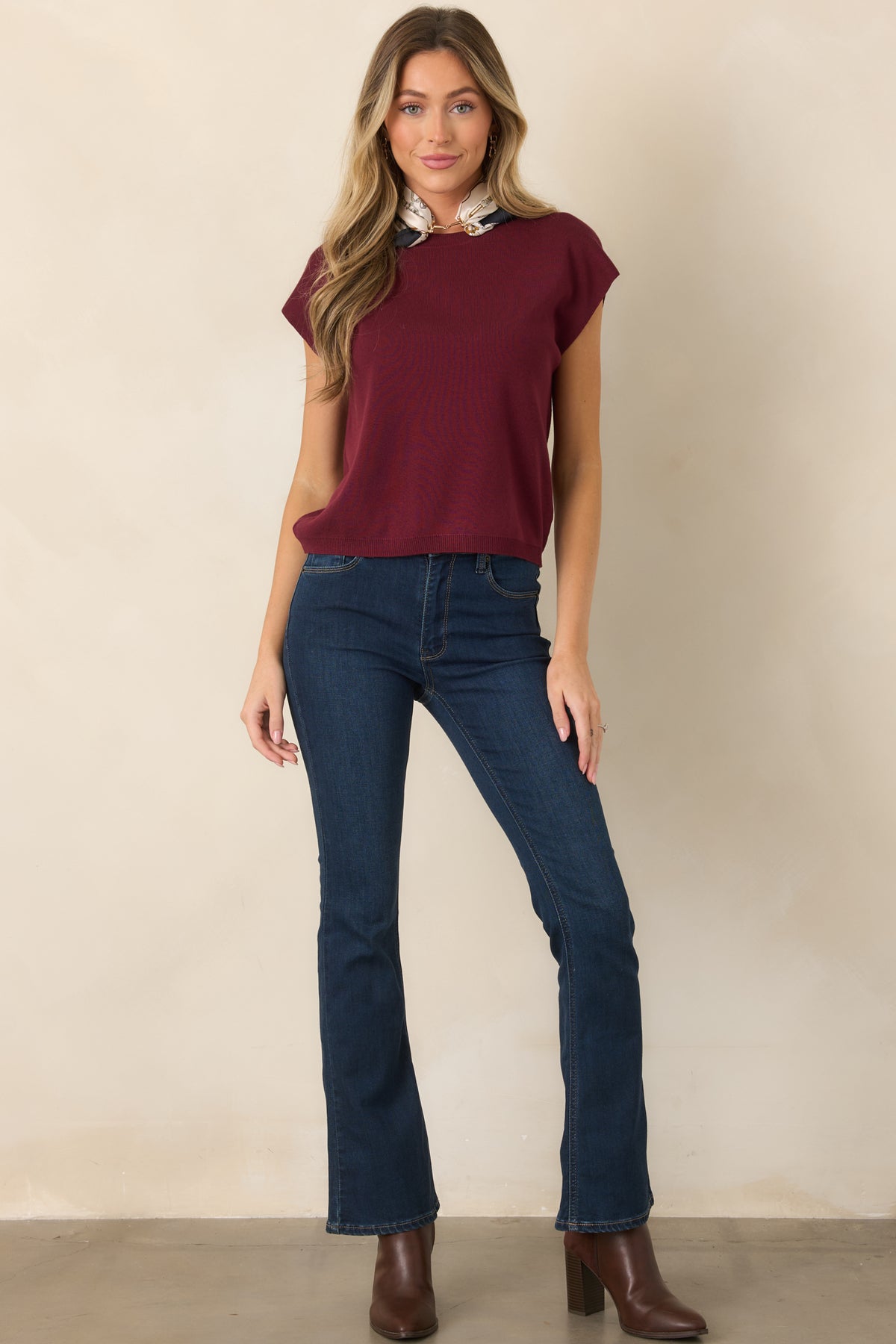 Polished short-sleeve sweater showcasing its clean crew neckline, straight shape, lightweight knit construction, and neatly ribbed hem.