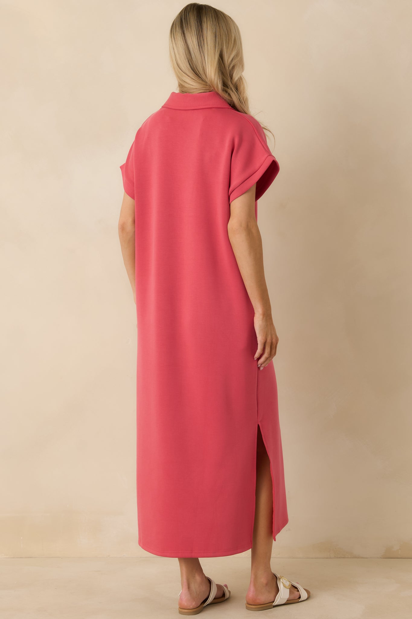 Coral pink midi dress shown from the back, featuring short sleeves and a clean, relaxed silhouette.