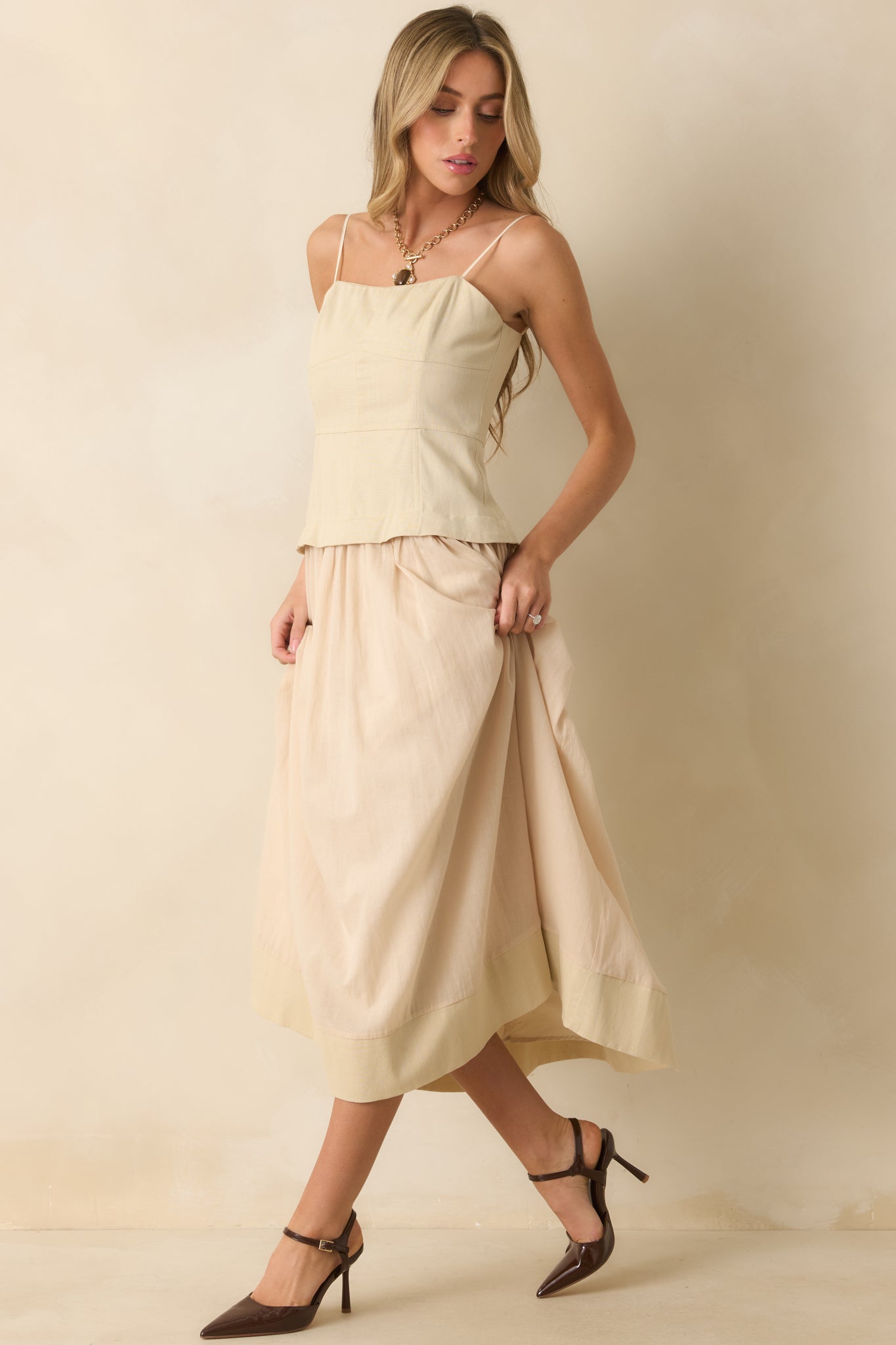 A side angle emphasizing the bustier paneling and full lining beneath the skirt.