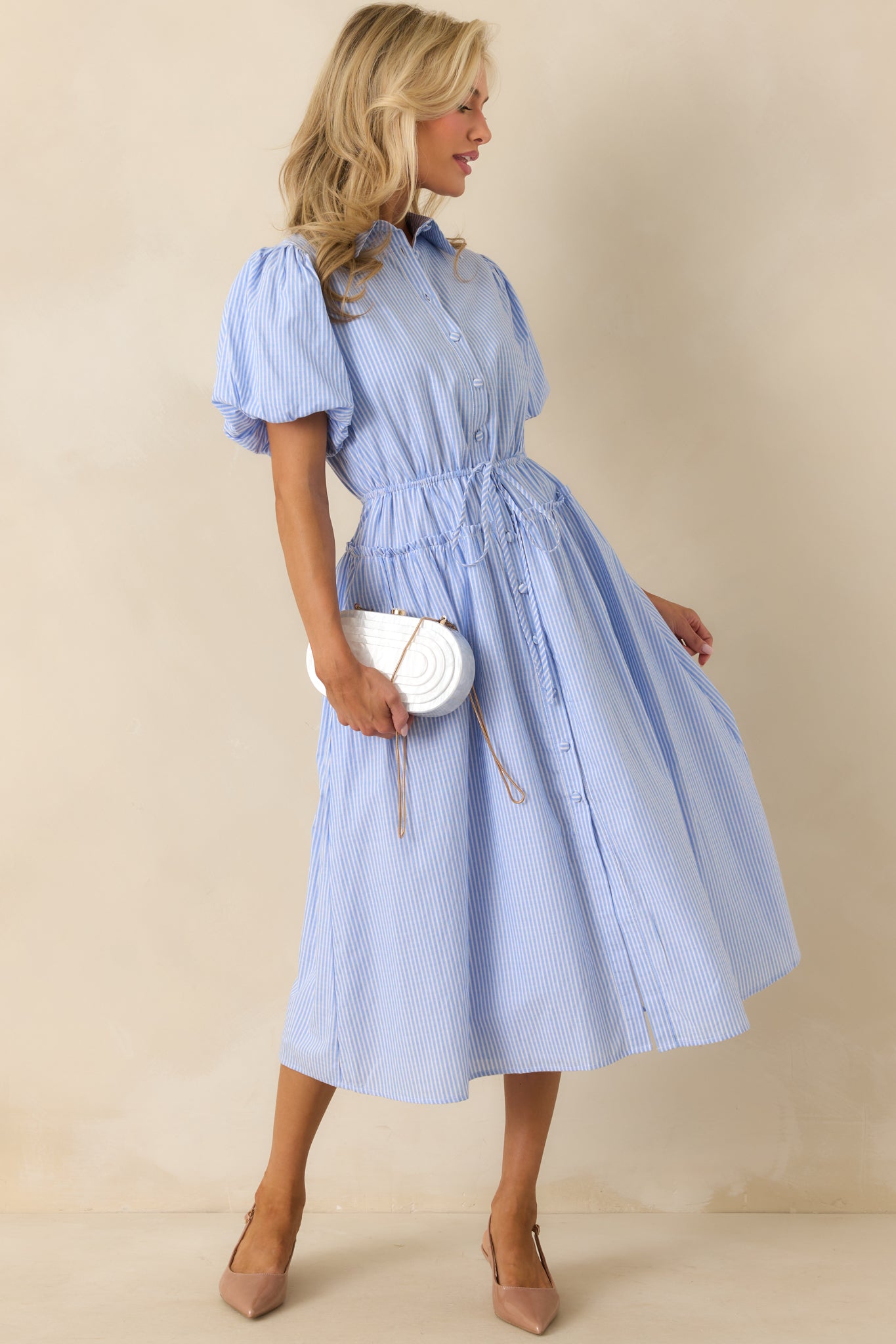Dress displayed with a slight side angle, highlighting the puff sleeves and elastic cuffs.