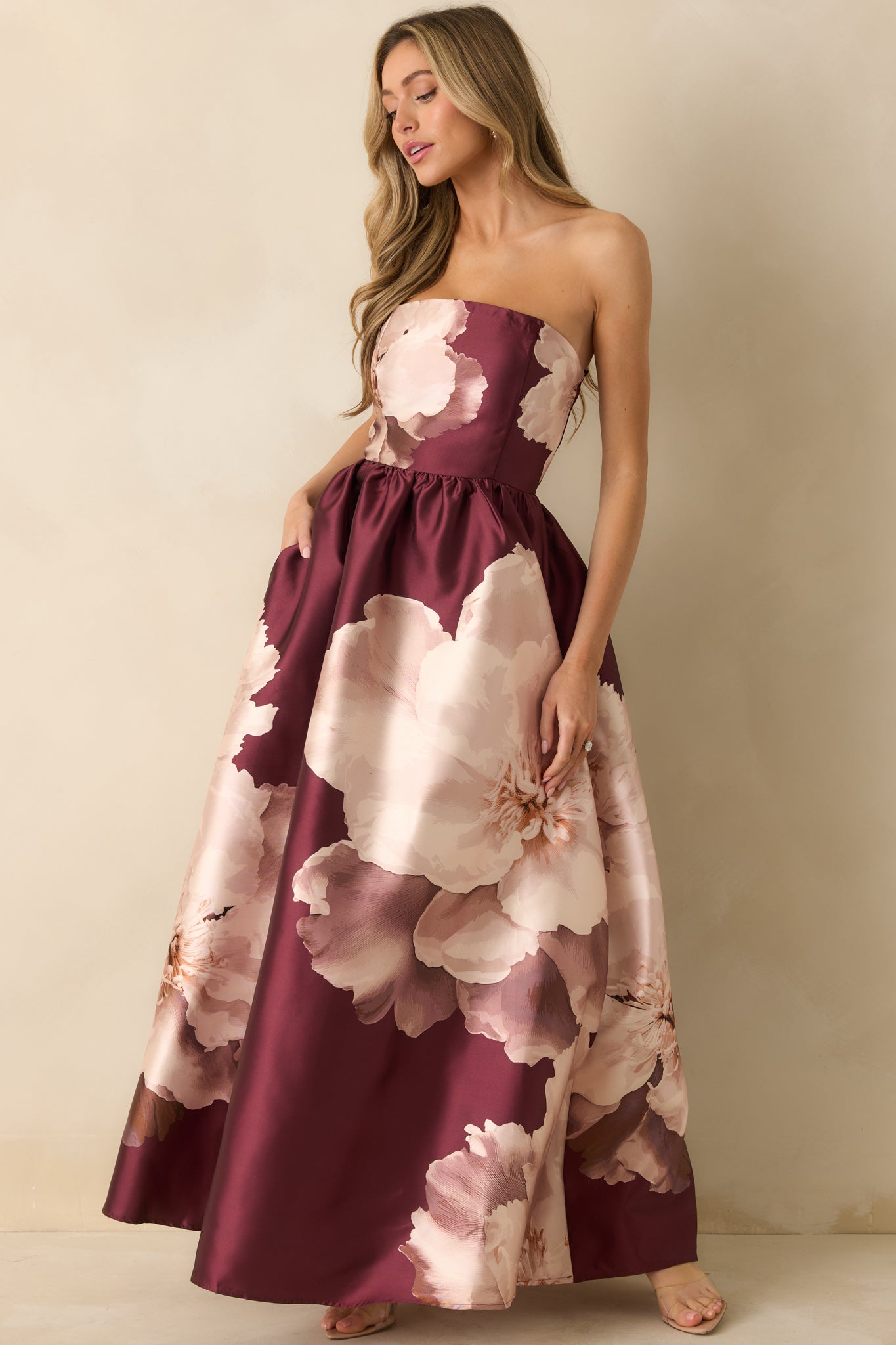 Slightly side-angled front view emphasizing the strapless neckline and soft drape of the satin A-line skirt.