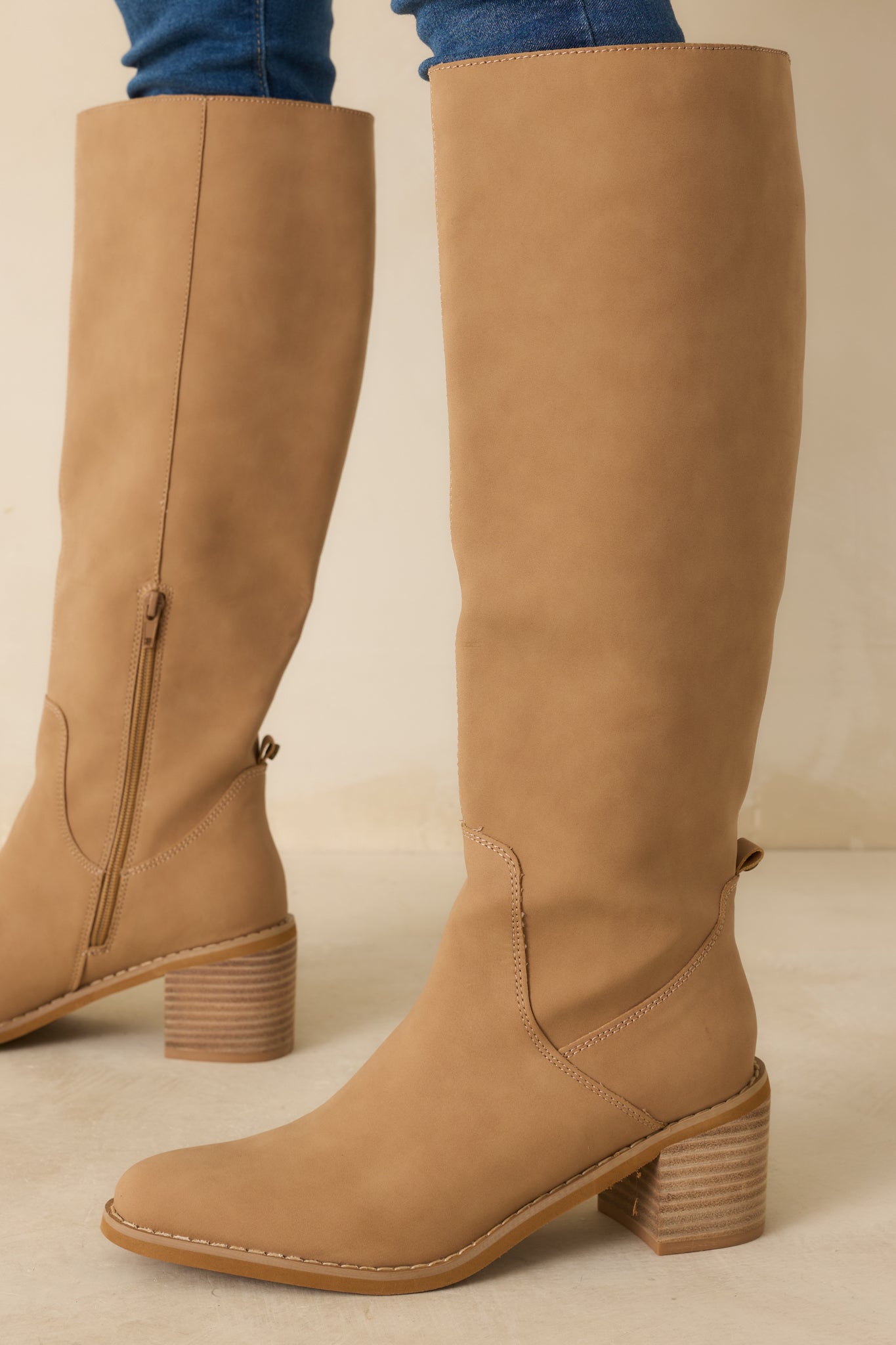 Side cropped view showing the inner zipper closure and smooth structure of the matte camel boots.