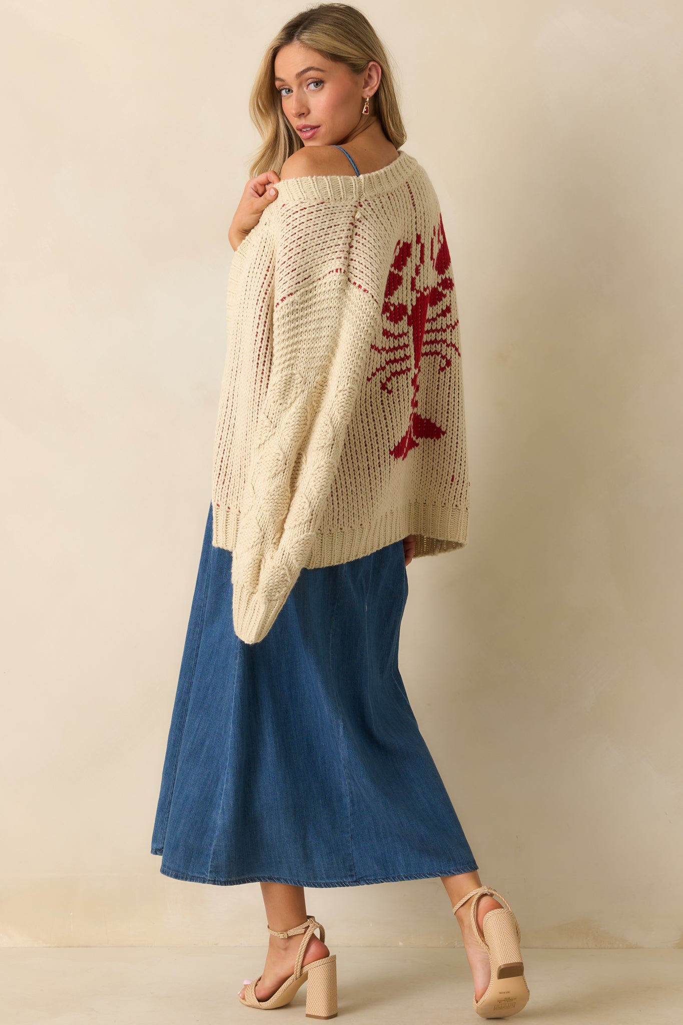 Side-facing shot of cardigan highlighting long balloon sleeves and relaxed fit.