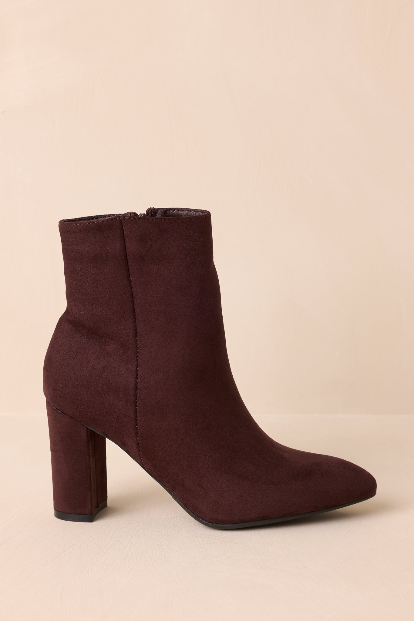 Side profile emphasizing the inner zipper closure and smooth faux suede finish.