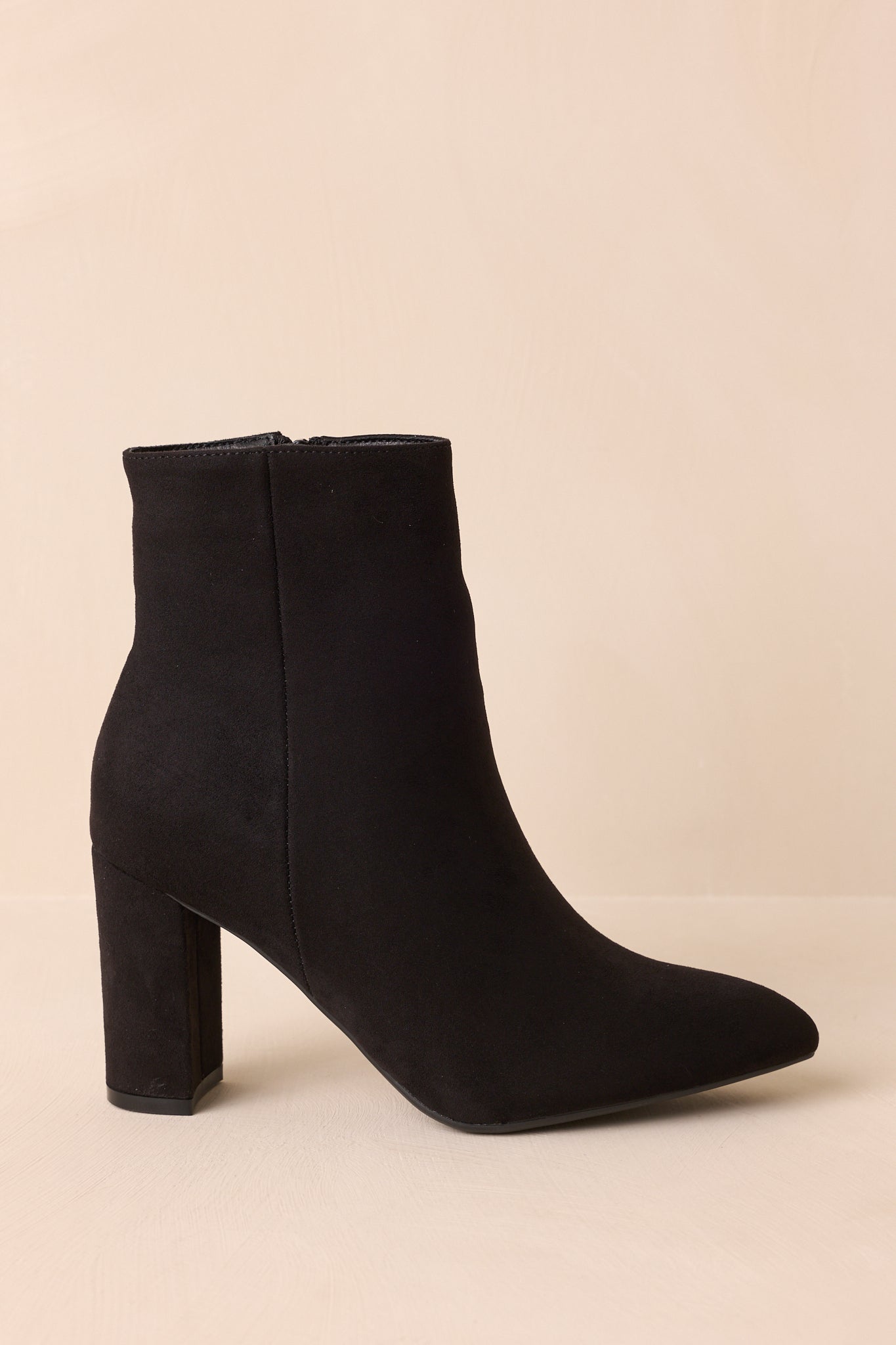 Side profile emphasizing the inner zipper and smooth faux suede finish.