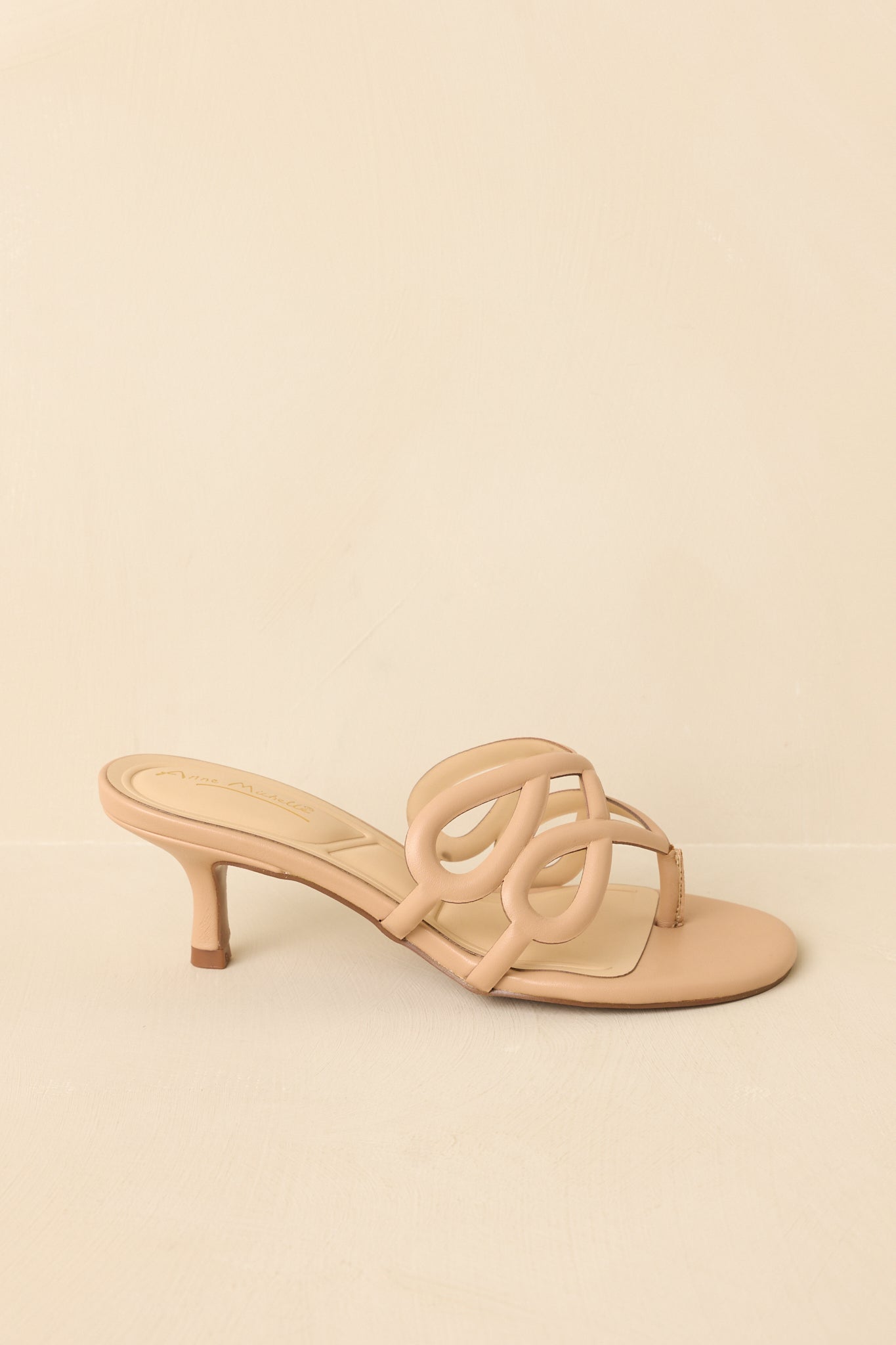 Side profile highlighting low kitten heel and minimalist silhouette.