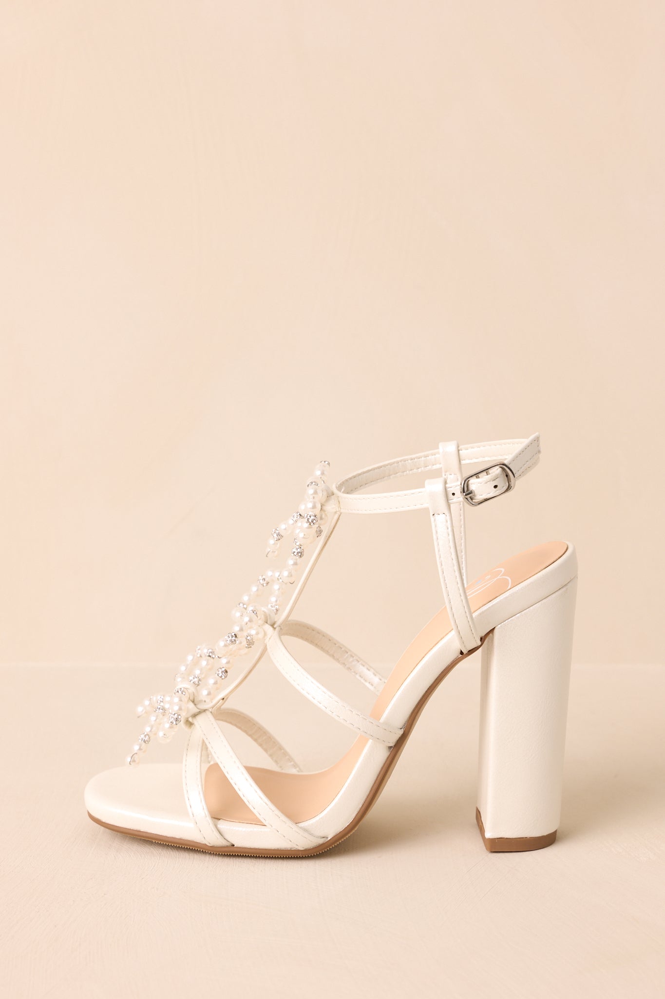 A side profile of the heel focusing on the block heel and clean, structured silhouette.