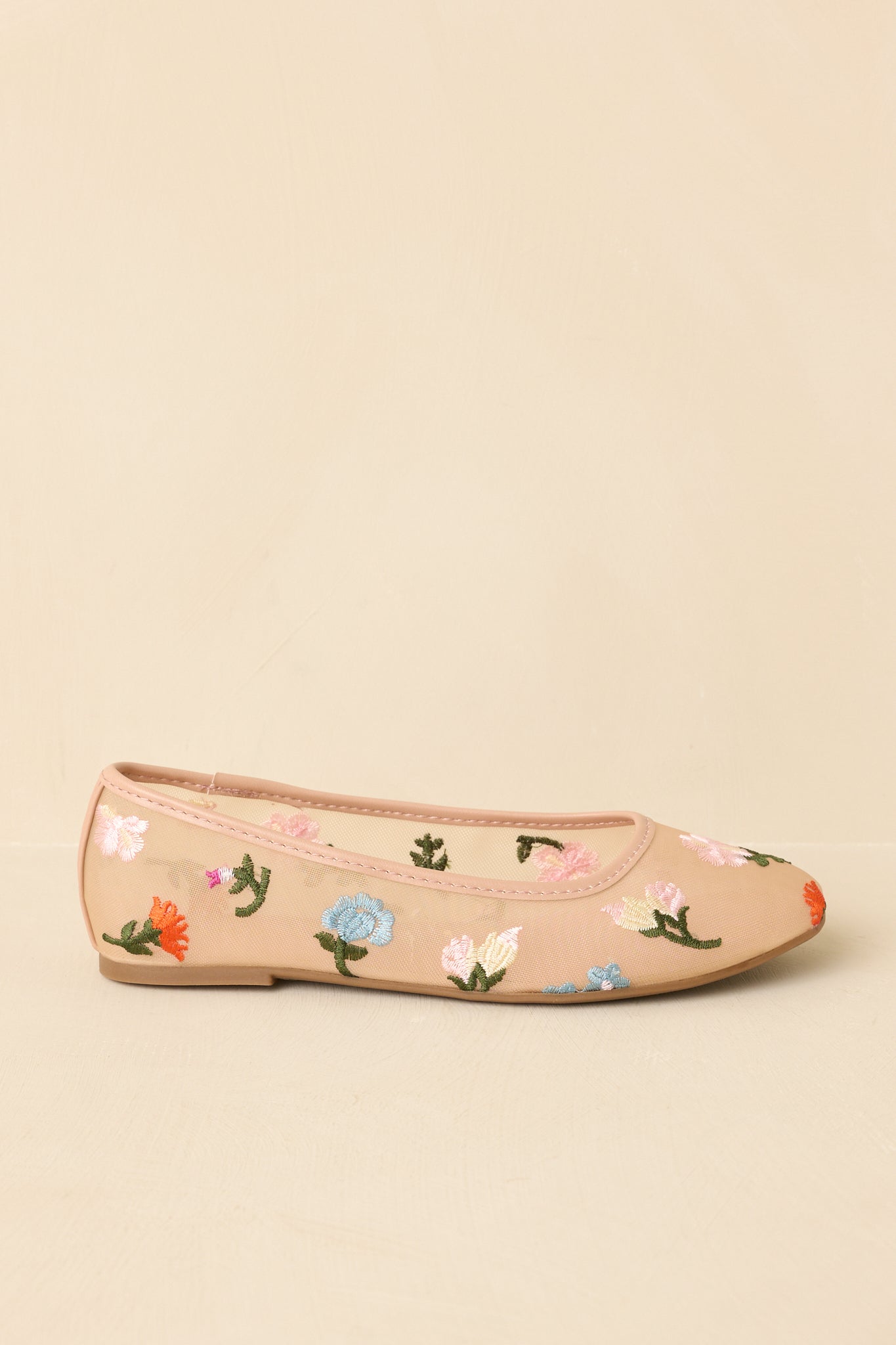 Side profile of nude mesh flats on beige background showing flat sole and streamlined silhouette