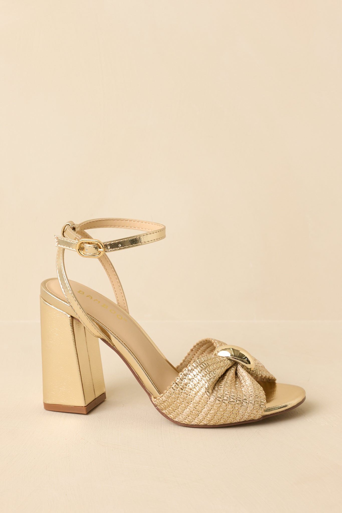 Side view highlighting the adjustable ankle strap, gold-tone center detail, and sturdy block heel.