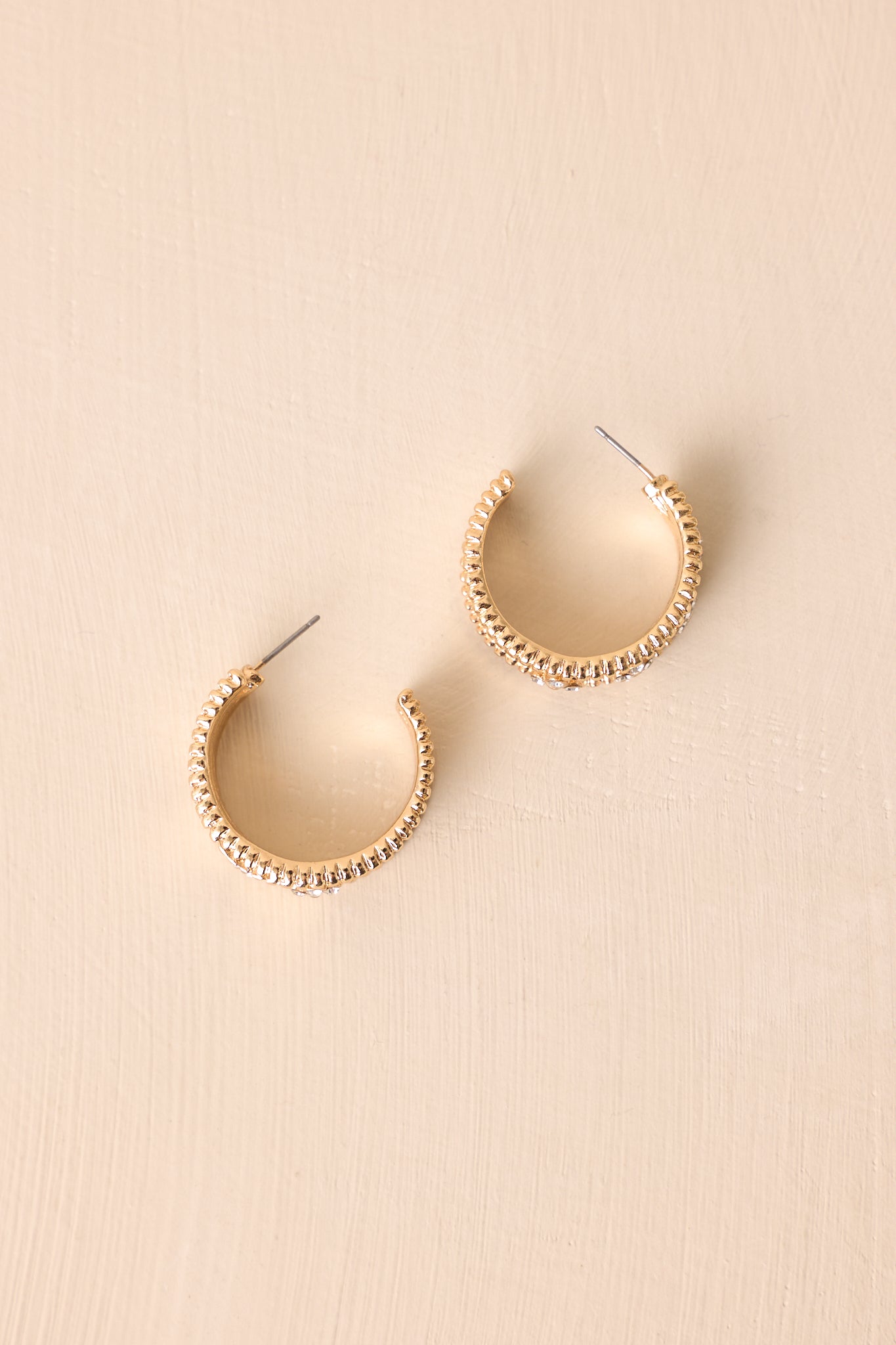 Side view of the half-hoop earrings highlighting the beaded edge and subtle brushed texture.