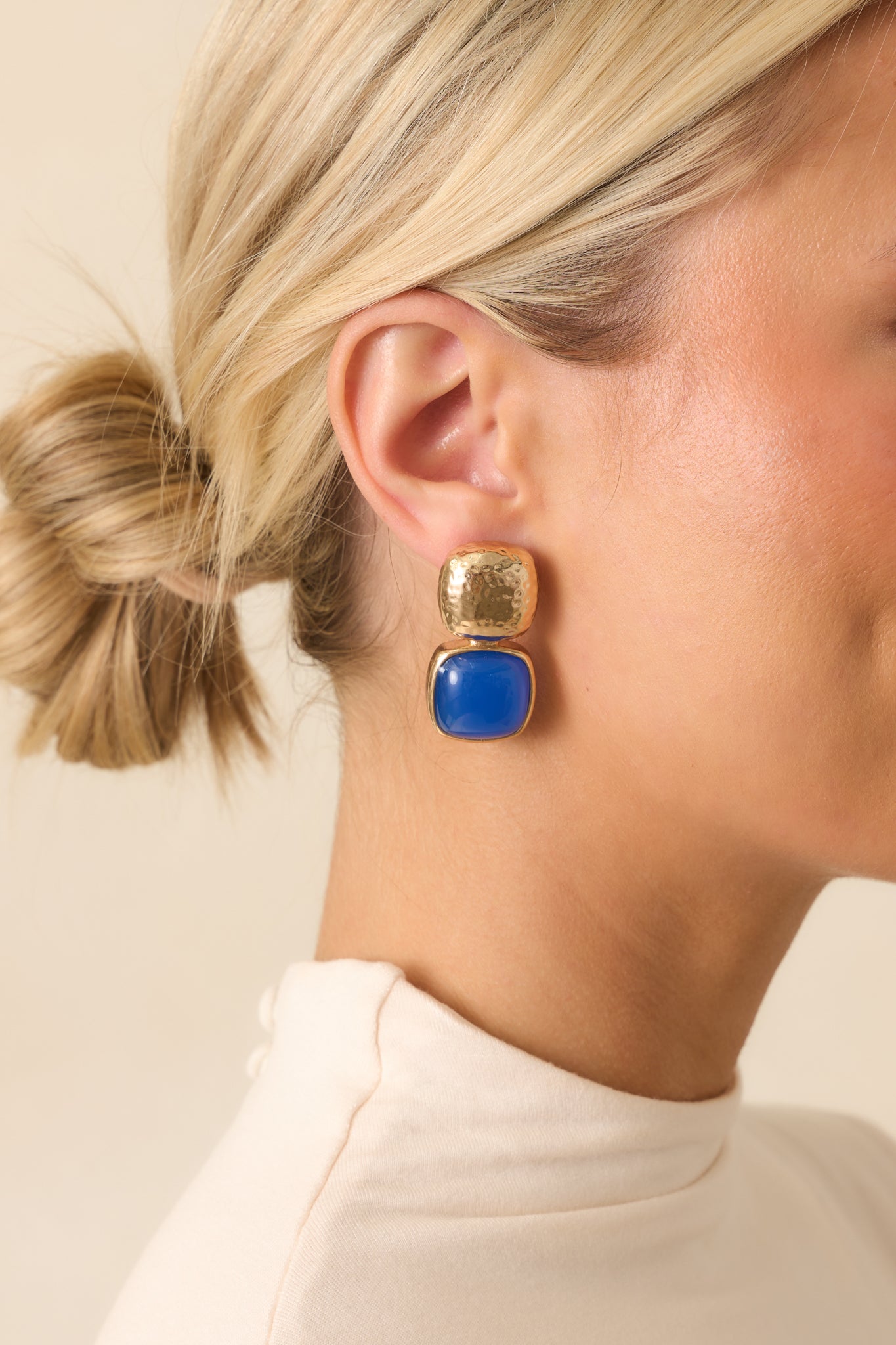 Side view highlighting the square blue stone and secure post backing.