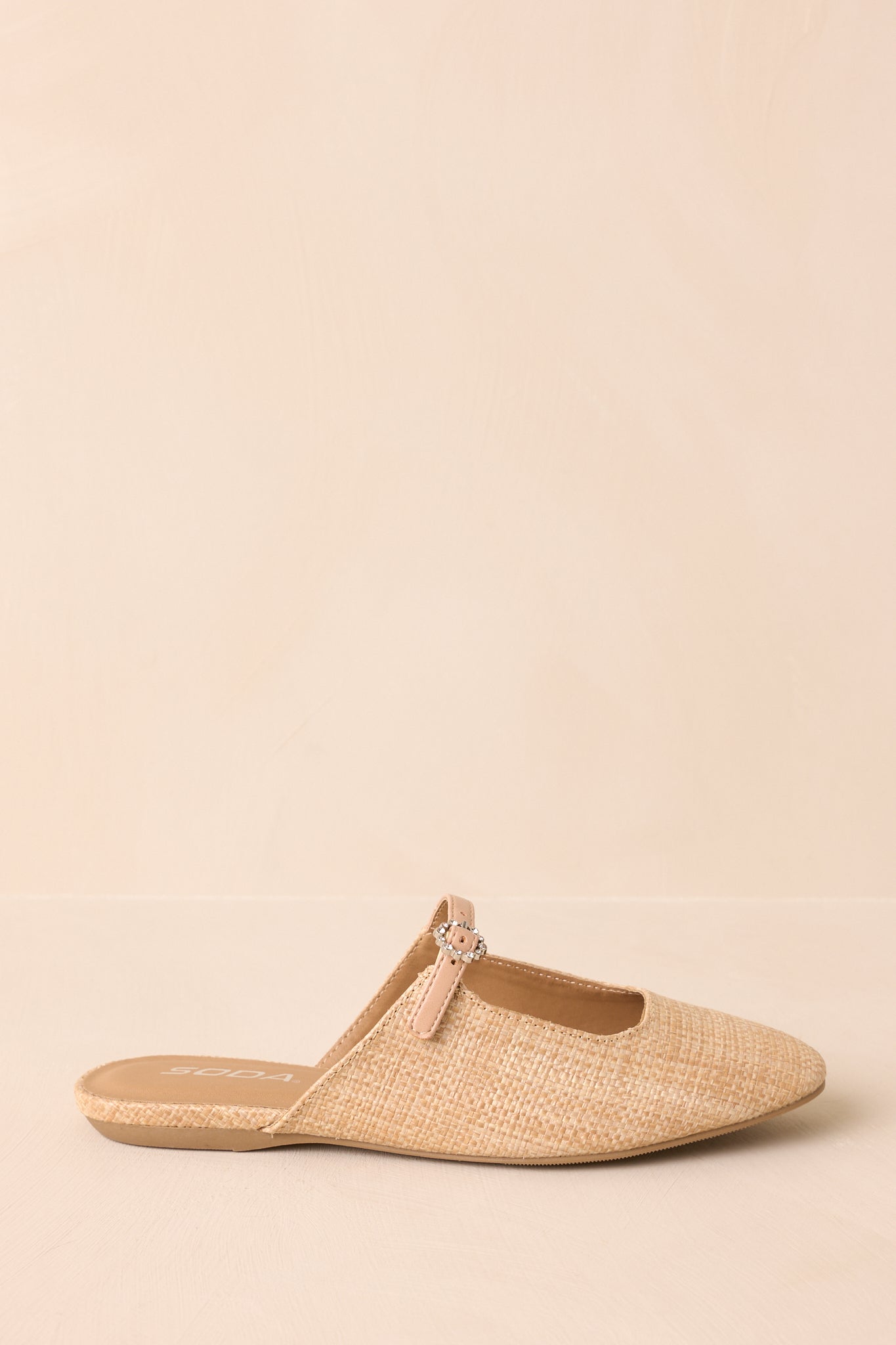 Side angle view highlighting the strap and slip-on mule silhouette.