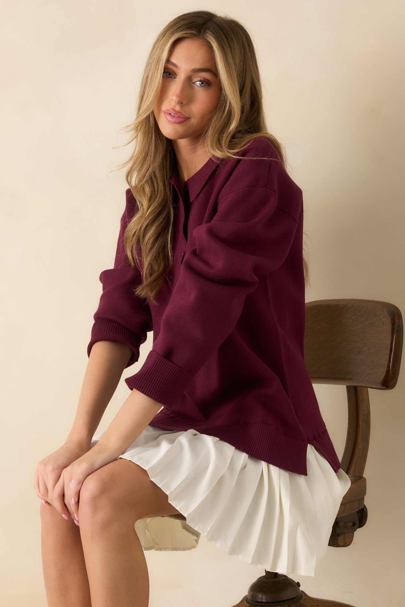 Side angled view showing soft knit texture, collared neckline, and long sleeve design.