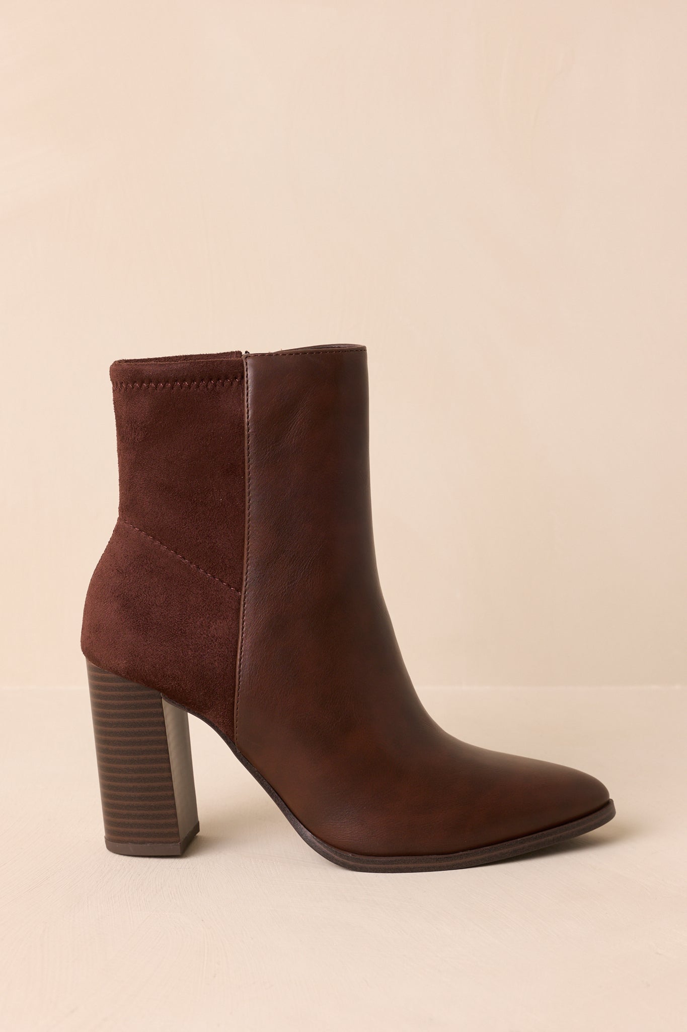 Side view of the brown ankle boots highlighting the stacked block heel and contrasting back panel.