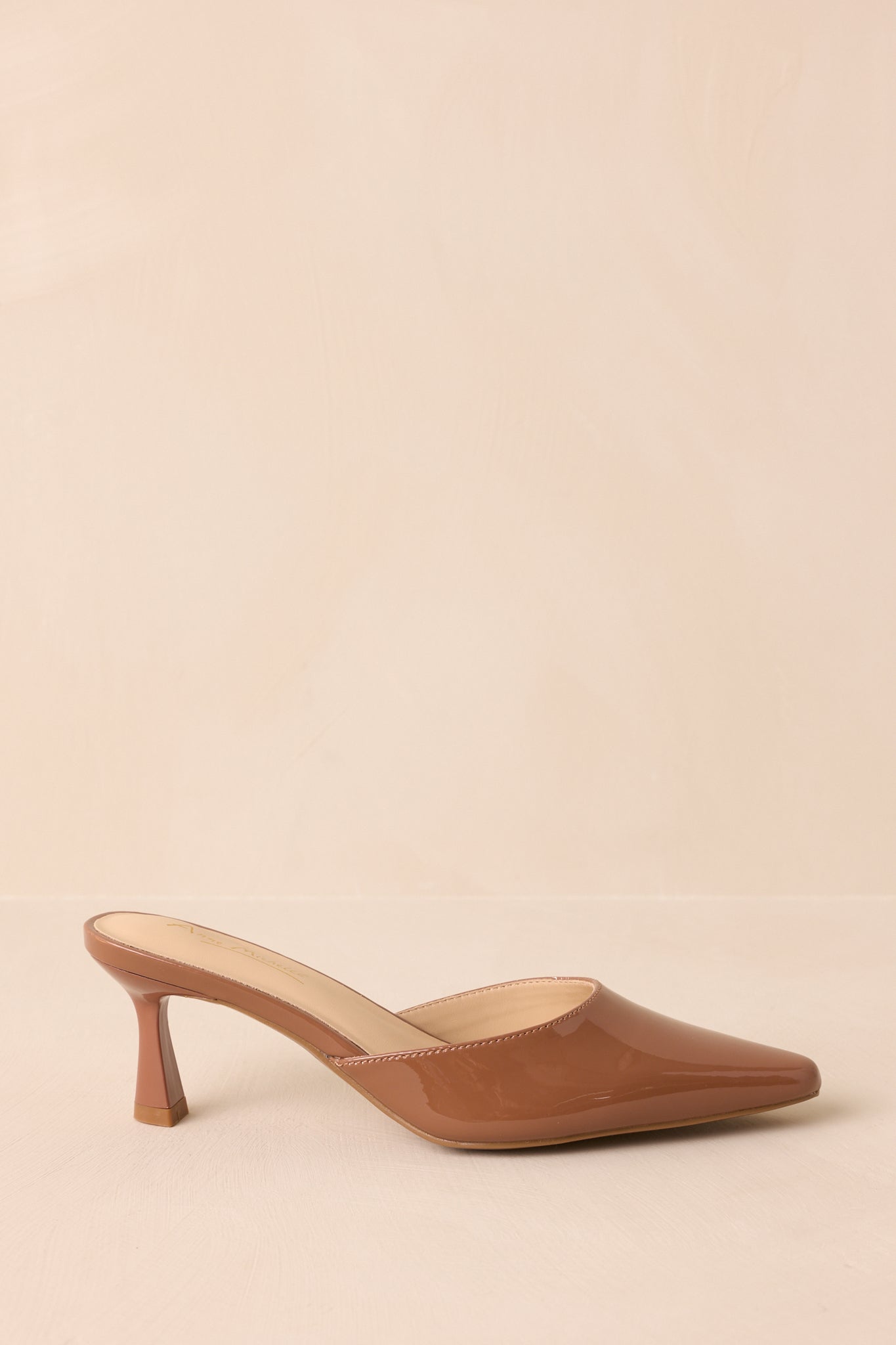 Side view of mocha brown slip-on mule highlighting pointed toe and kitten heel.