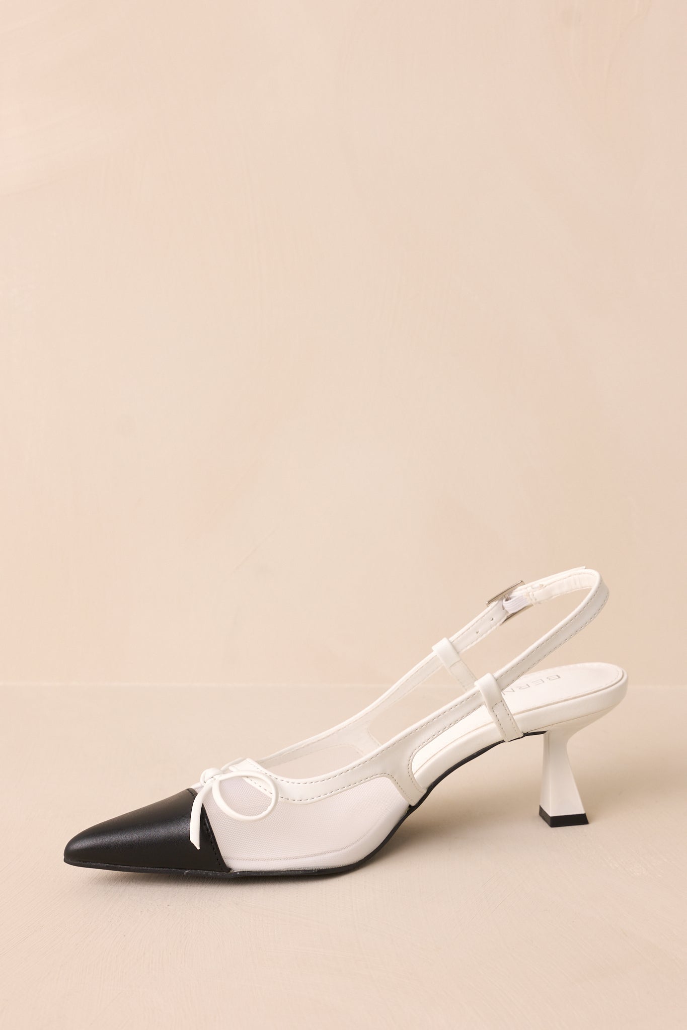 Side view of the heels showing the adjustable slingback strap and kitten heel profile.