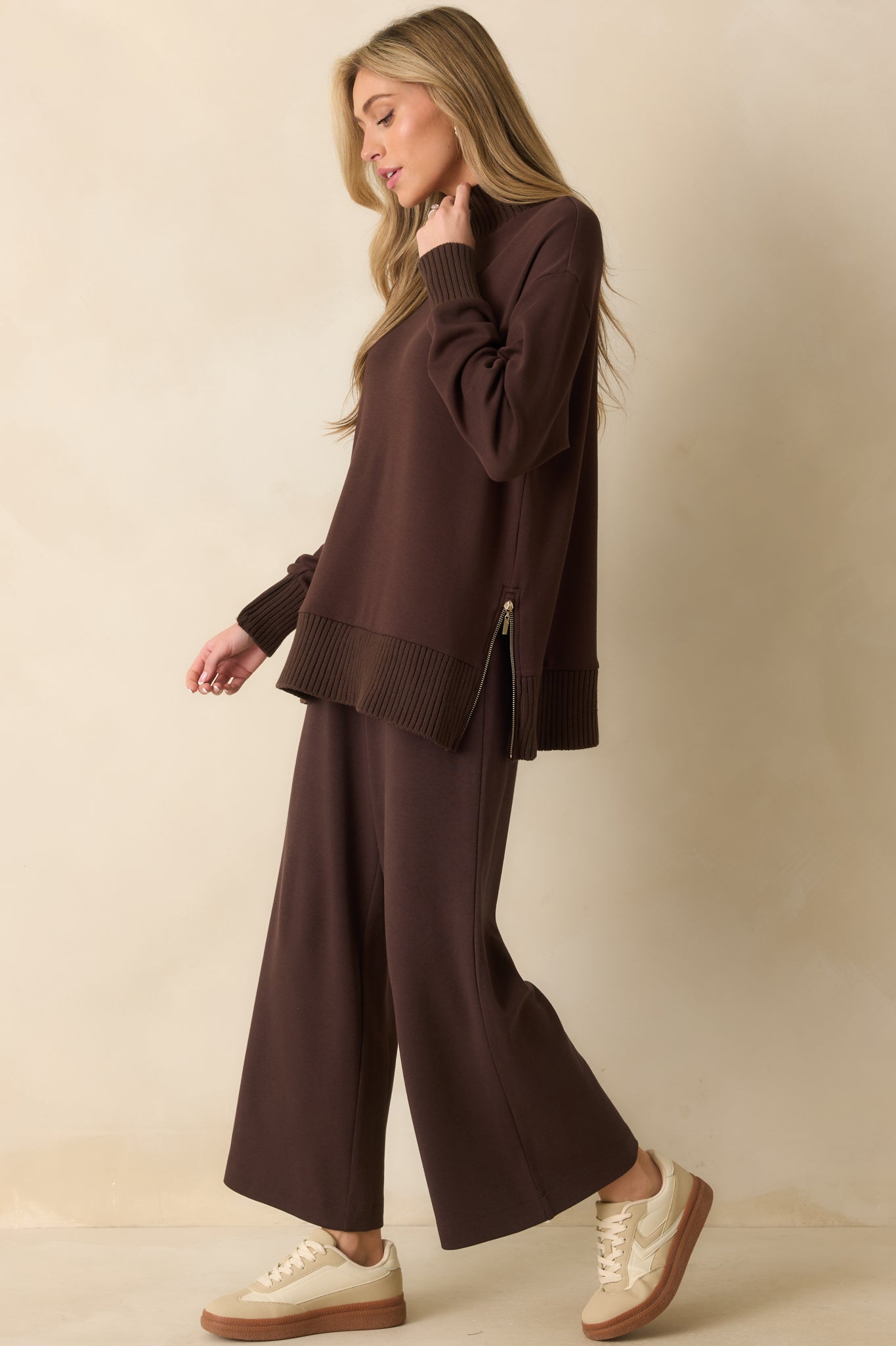 A side shot highlighting the oversized fit and adjustable side zipper details.