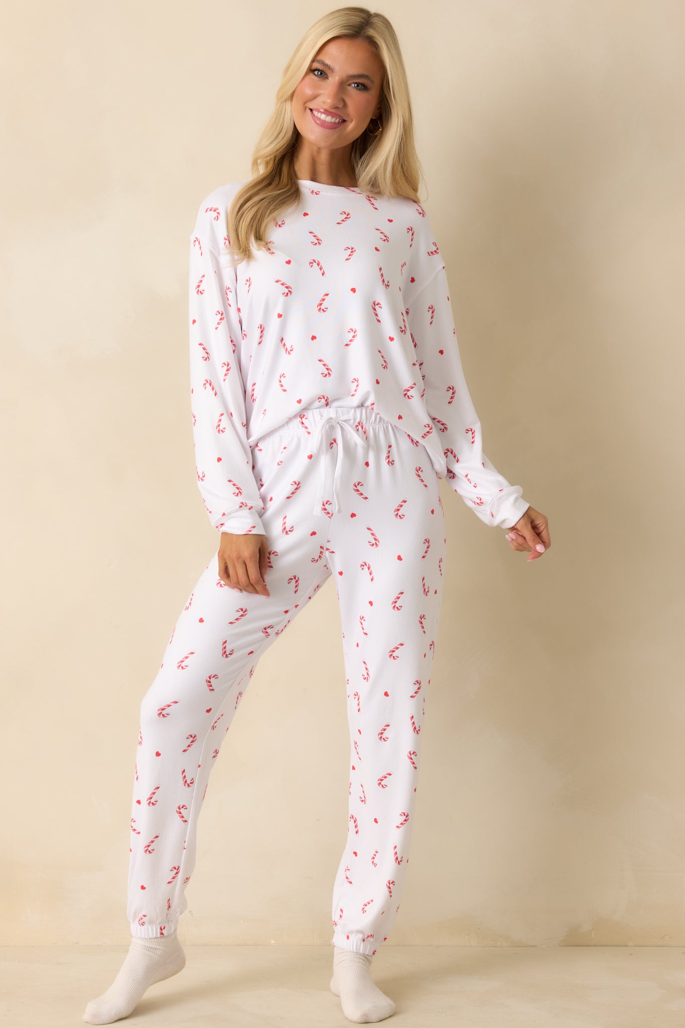 Silky white knit pajama pants with relaxed fit, cuffed hems, and soft, lightweight jersey texture.