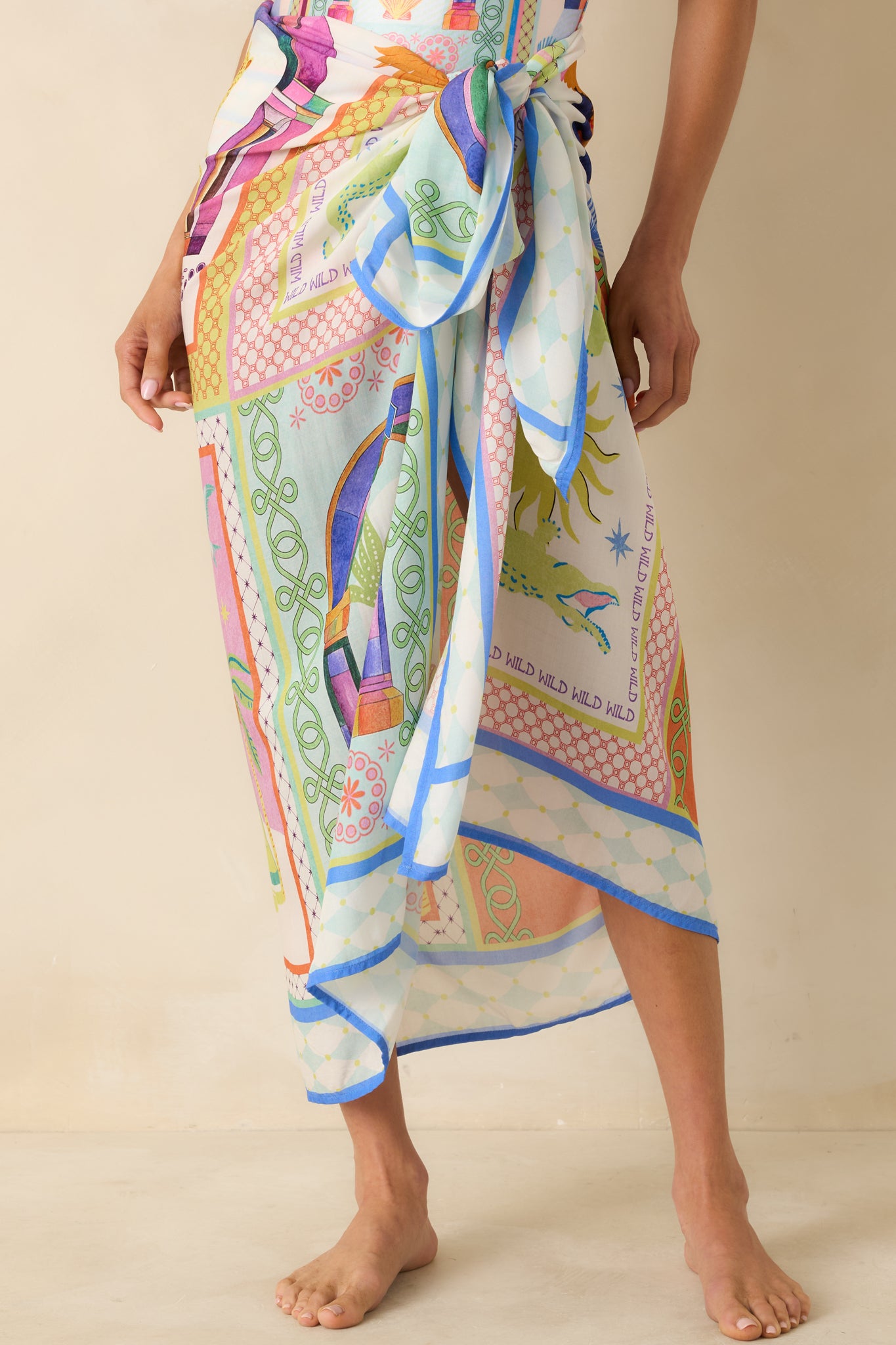 Close view of silky sarong fabric with contrast blue edging and fluid drape.